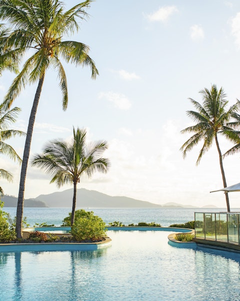 A collection of photographs showcasing the turquoise waters, pristine beaches, and sailing activities of Lizard Island and The Whitsundays.