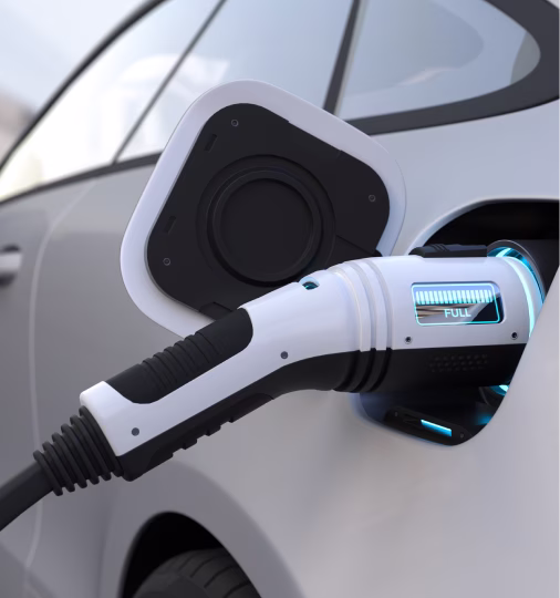 Close-up of an electric vehicle charging port with a charging cable inserted showing a 'FULL' battery indicator.
