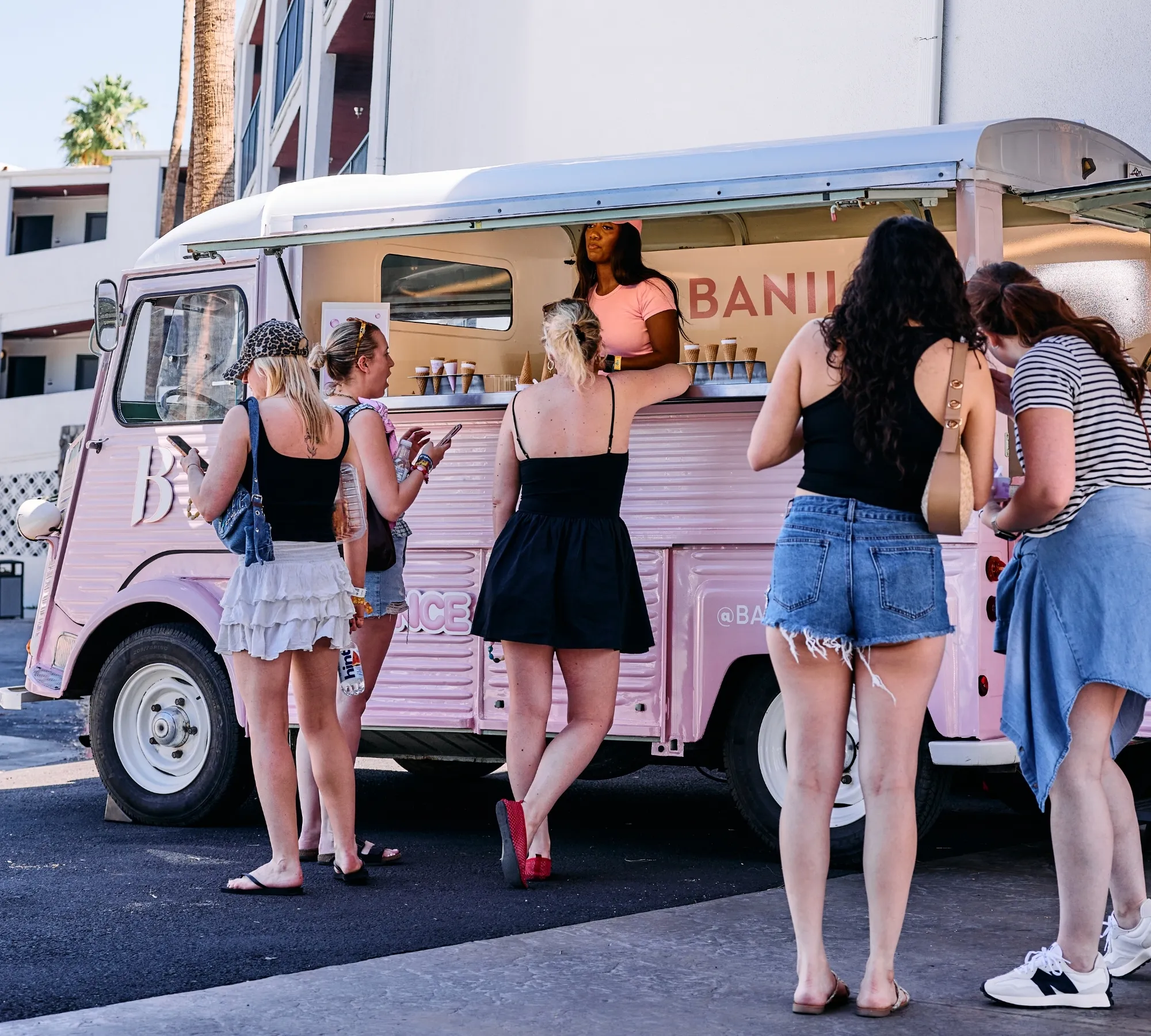 Festivalgoers receiving frozen treats and Banila Co skincare samples from a Retro Roll Citroën HY activation van in Palm Springs. 