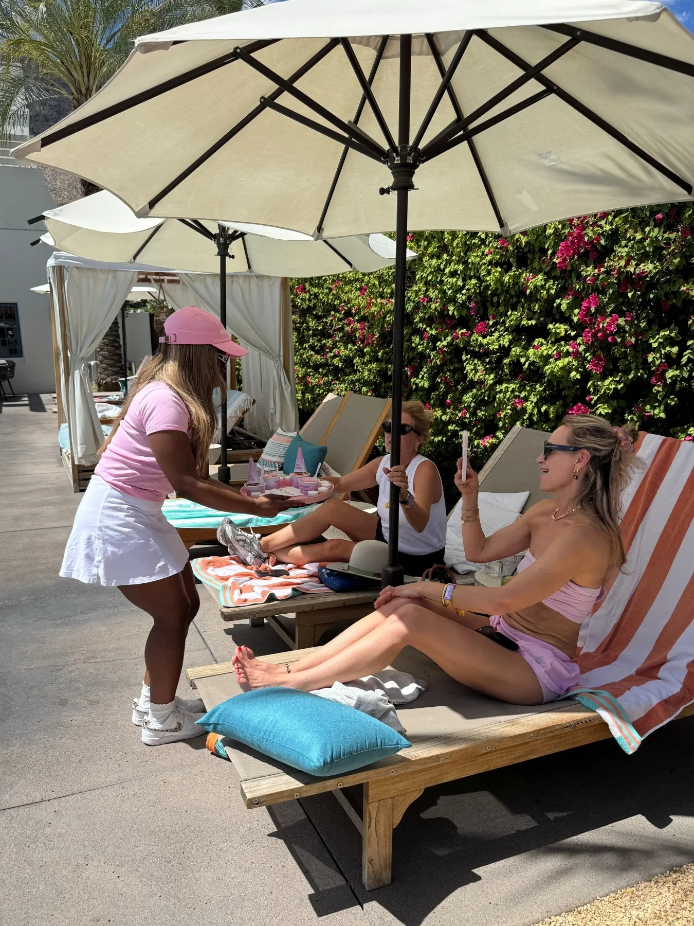 Banila Co brand ambassador delivering product samples to hotel guests poolside during the Palm Springs activation. 