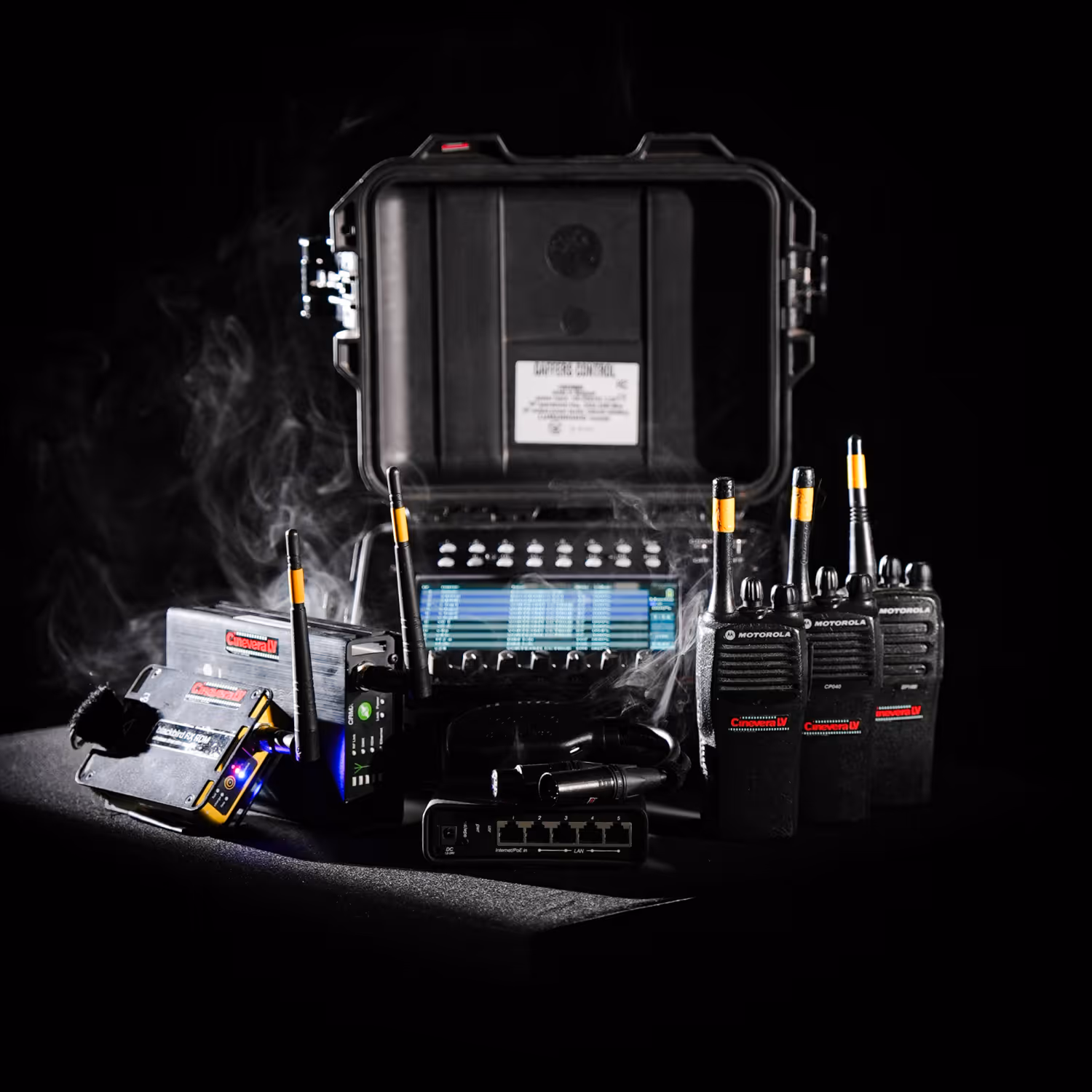Communication equipment including radios, transmitters, and a control panel in a black case.
