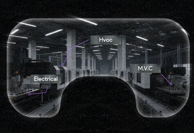 View through augmented reality goggles showing a factory floor with labeled sections: Electrical, HVAC, and M.V.C.