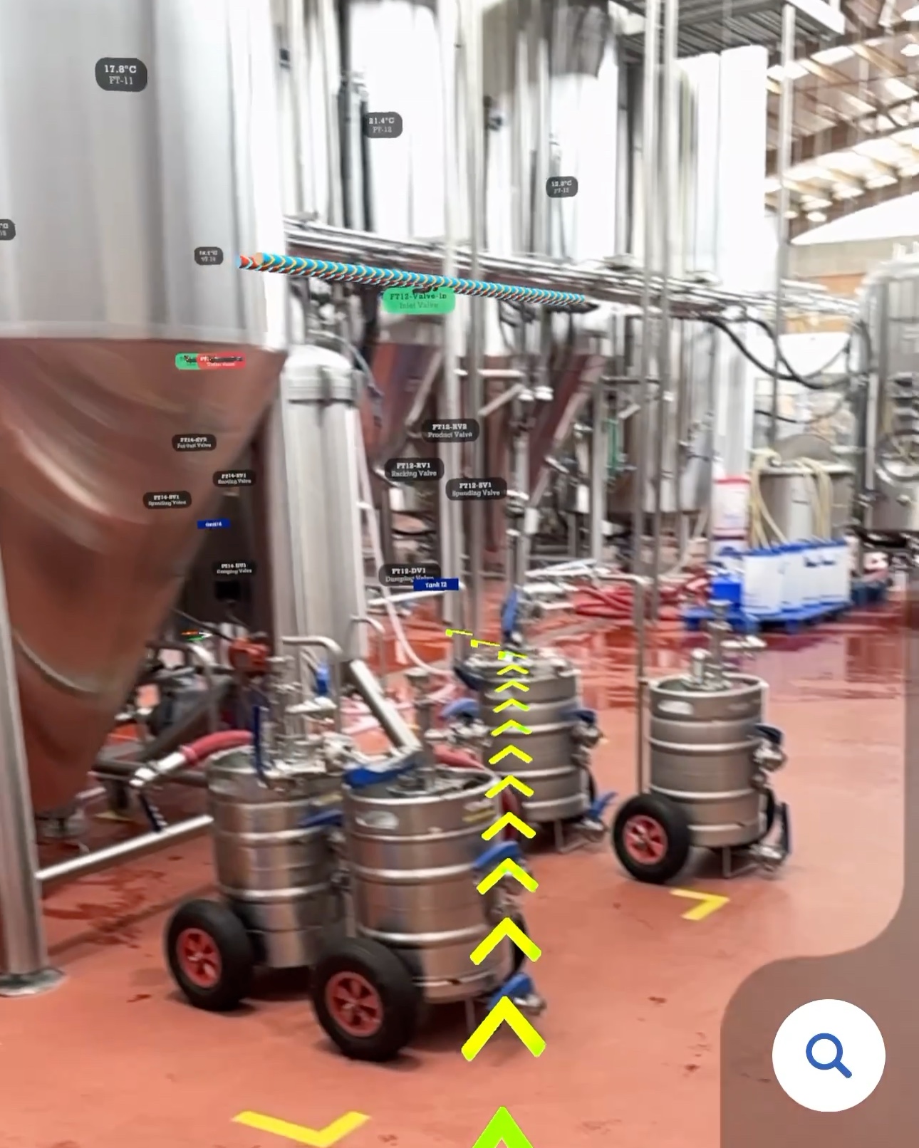 Phone view of the brewery aisle with a yellow arrow route on the floor and named valves labelled on the fermenters