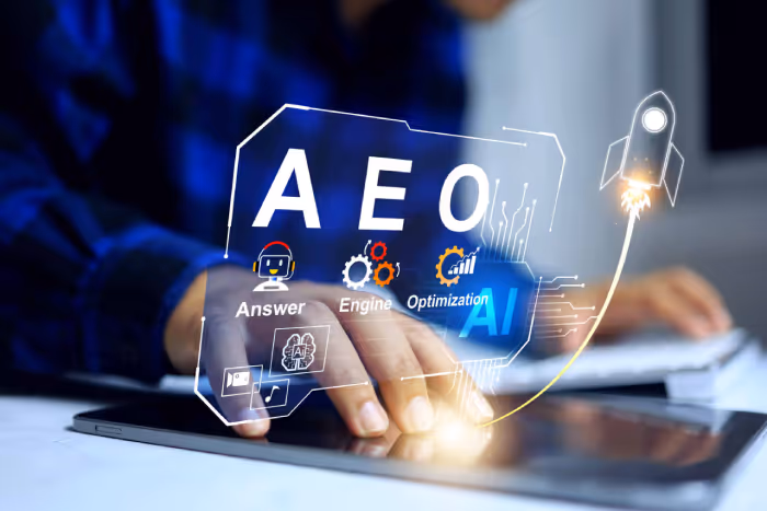 Person using a tablet with floating digital icons and text showing 'AEO' and 'Answer Engine Optimization AI' alongside a rocket graphic.