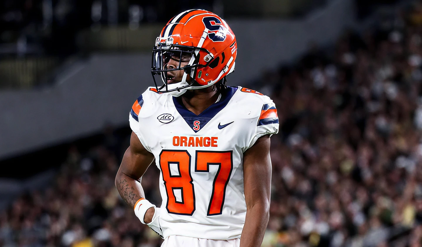 Syracuse Orange football player wearing number 87 jersey and orange helmet on the field.