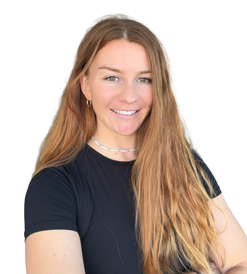 Smiling woman with long light brown hair wearing a black shirt, silver hoop earrings, and a beaded necklace, posing indoors in a bright room.