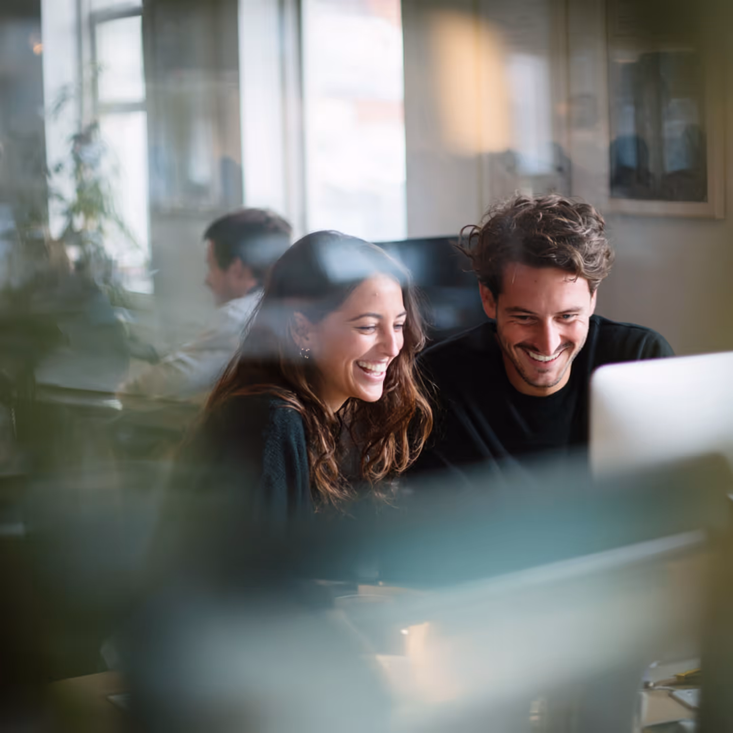 Photo - Two People Looking At A Computer Screen Smiling