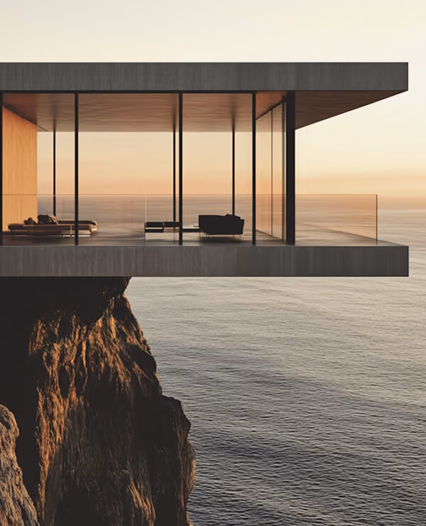 Modern glass-walled house cantilevered over rocky cliff with ocean view at sunset.