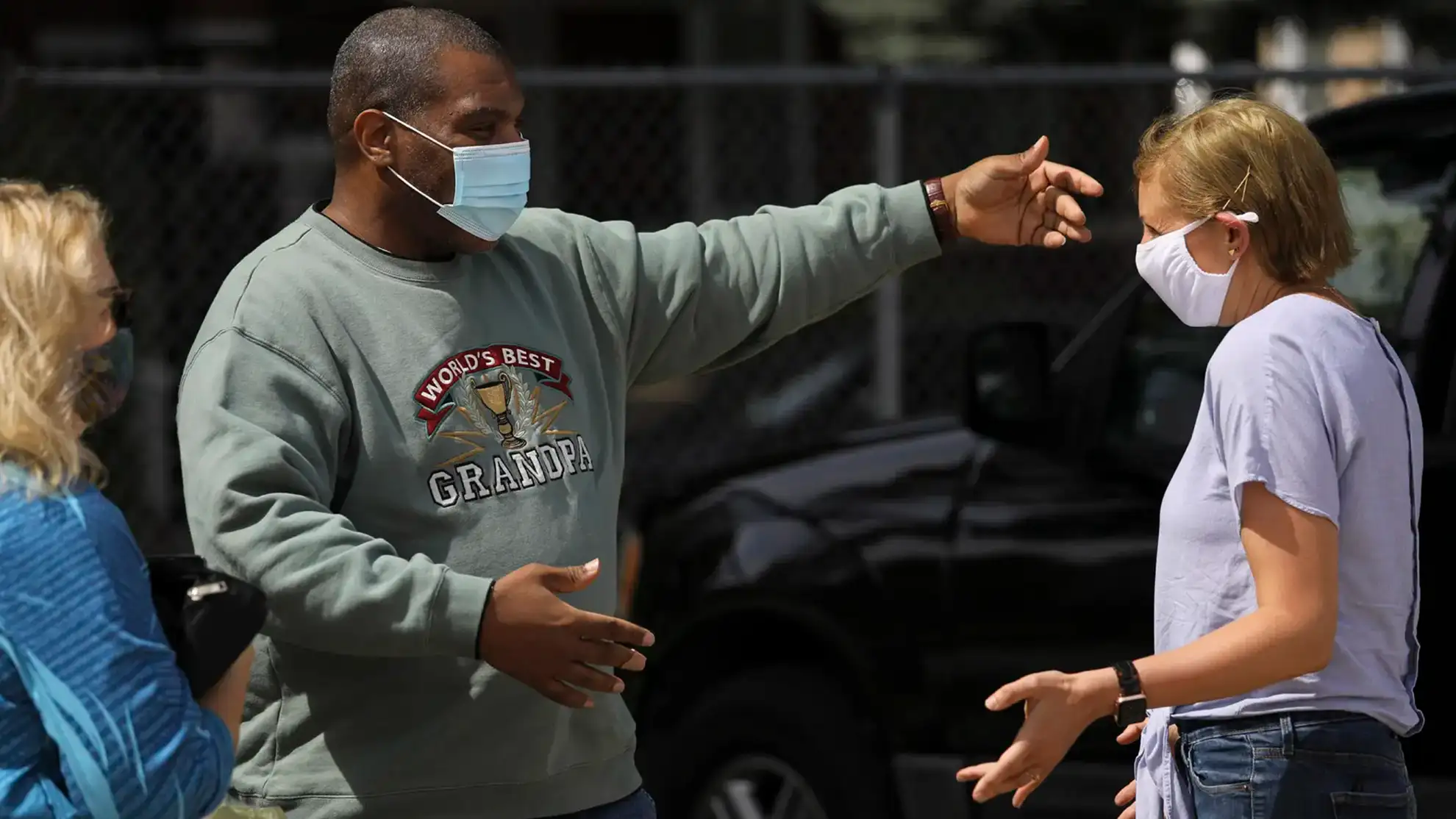 Jennifer Soble and man huggging, wearing face masks.