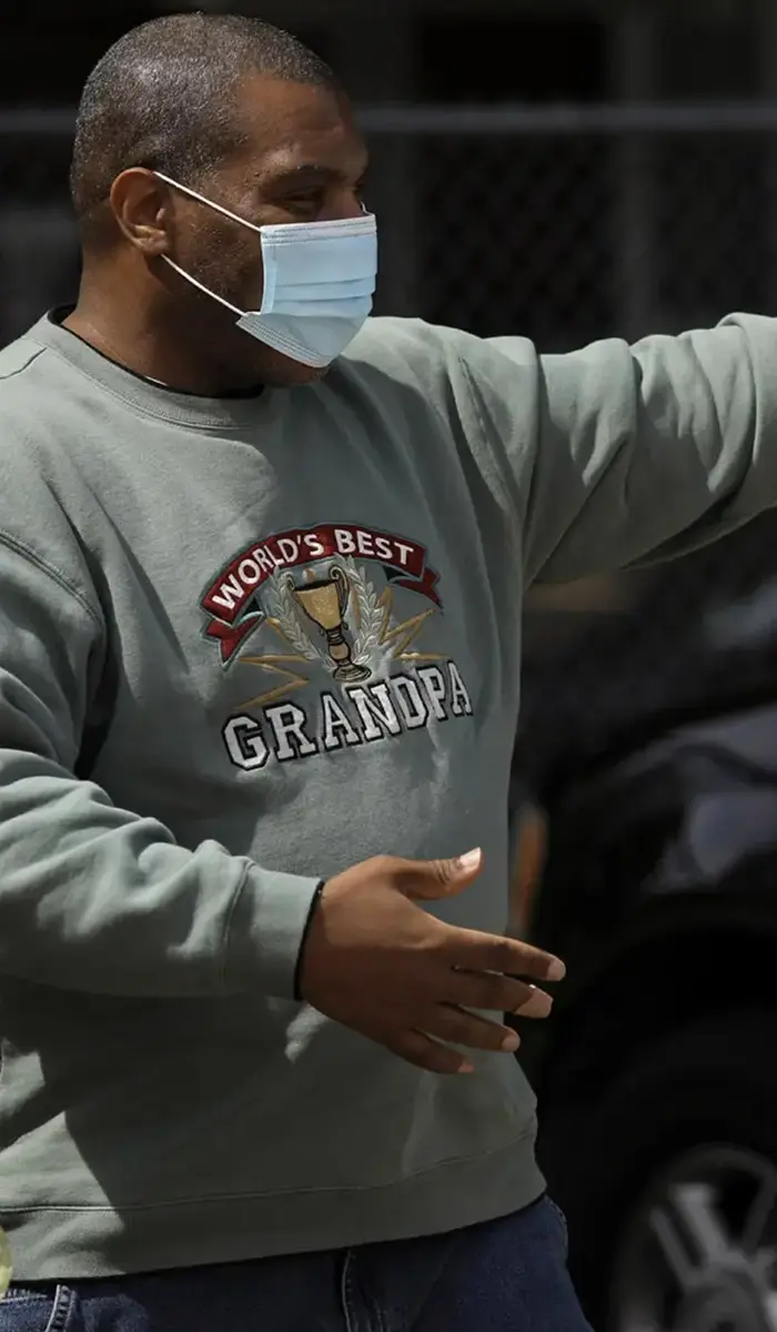 Jennifer Soble and man huggging, wearing face masks.