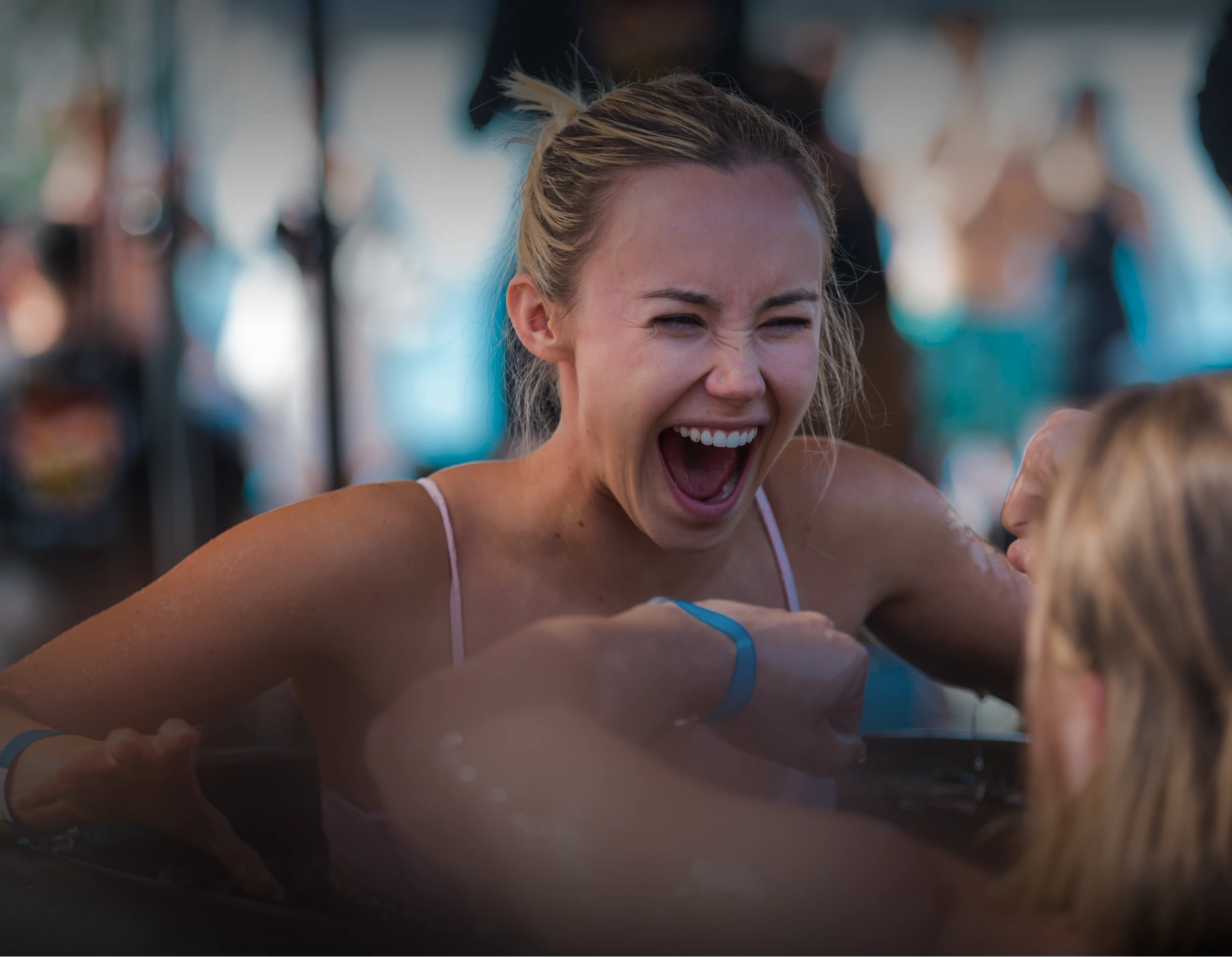 Man with raised arms and closed eyes appearing to be in a moment of deep emotion or meditation at an outdoor event.