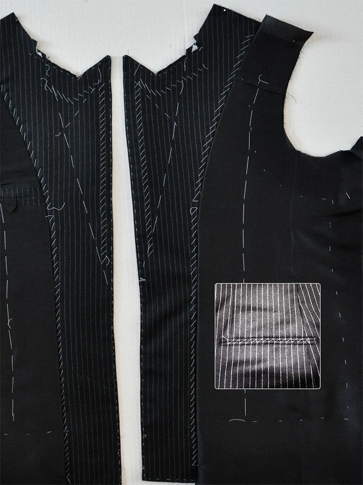 Black pinstripe jacket pattern pieces with hand tacking and a close-up inset of aligned seams.