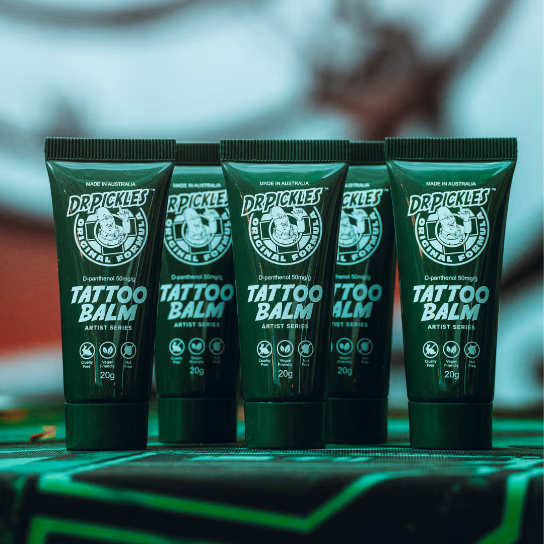 Five green tubes of Dr Pickles Tattoo Balm with original formula, standing upright in a row.