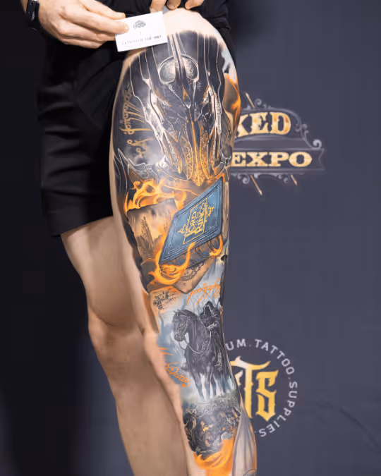 Full leg sleeve tattoo featuring a dark armored knight helmet, flaming book, and a horse rider in monochrome and orange hues.