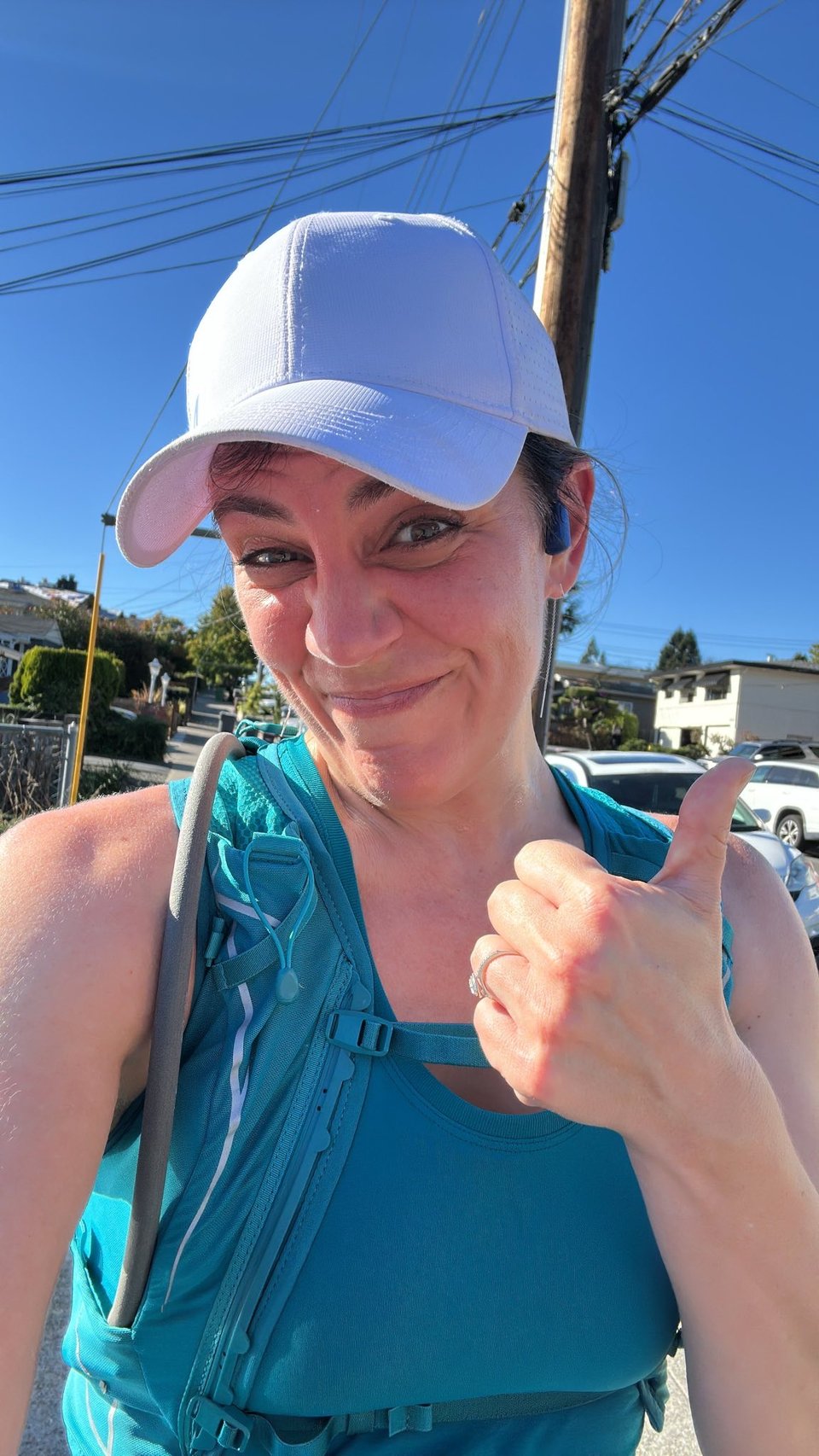Liz, after a run, with a sweaty red face, giving the camera an ironic thumbs up 
