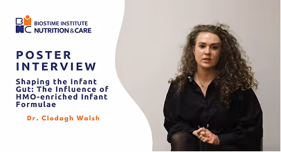 Woman with curly hair in black attire seated, next to text about a Biostime Institute Nutrition & Care poster interview on shaping the infant gut by Dr. Clodagh Walsh.
