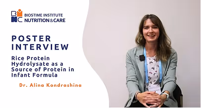 Dr. Alina Kondrashina sitting and smiling during a poster interview about rice protein hydrolysate as a source of protein in infant formula.