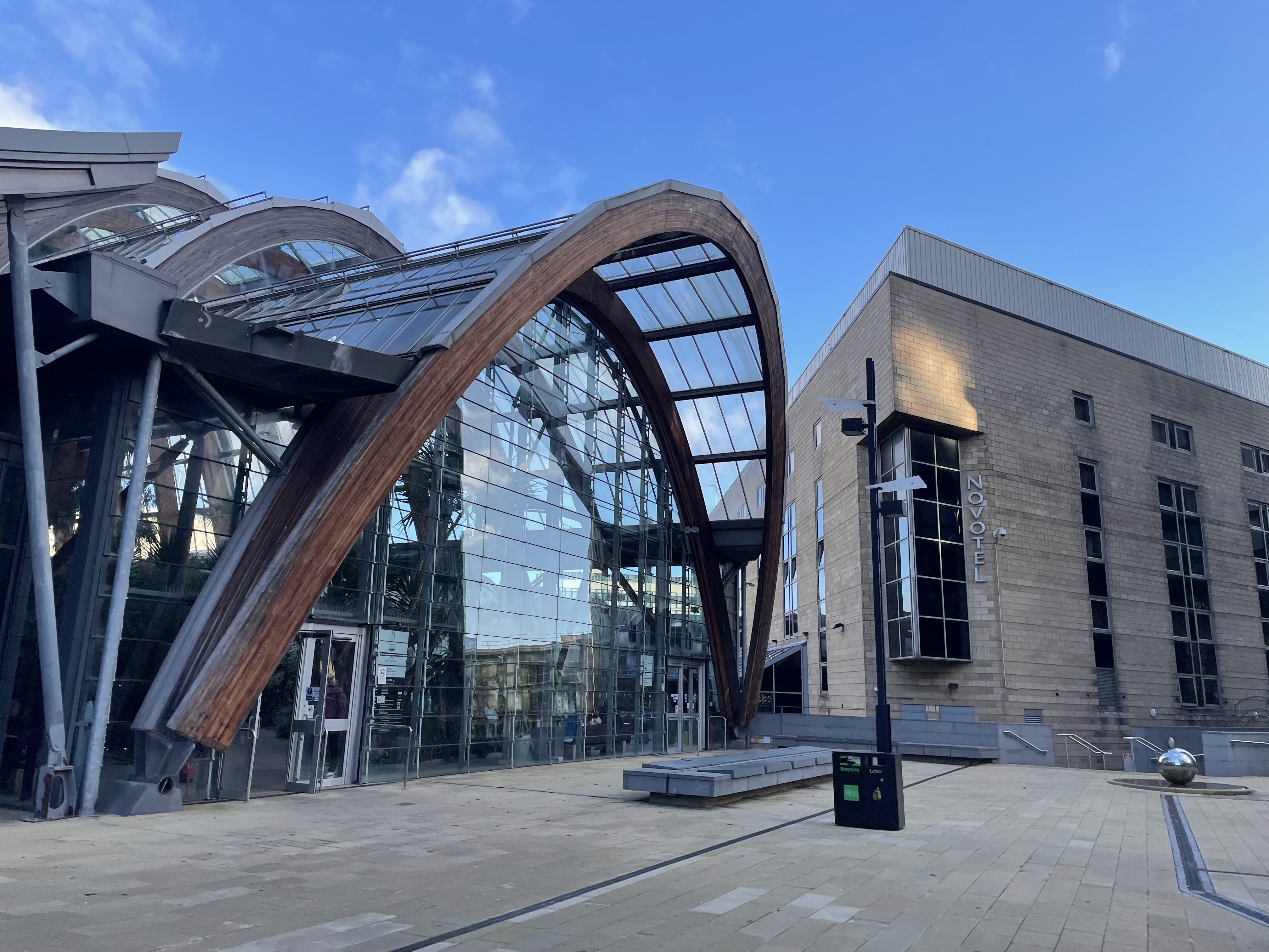 Entrance to the Winter Garden in Sheffield, a large glass greenhouse with wooden arches.