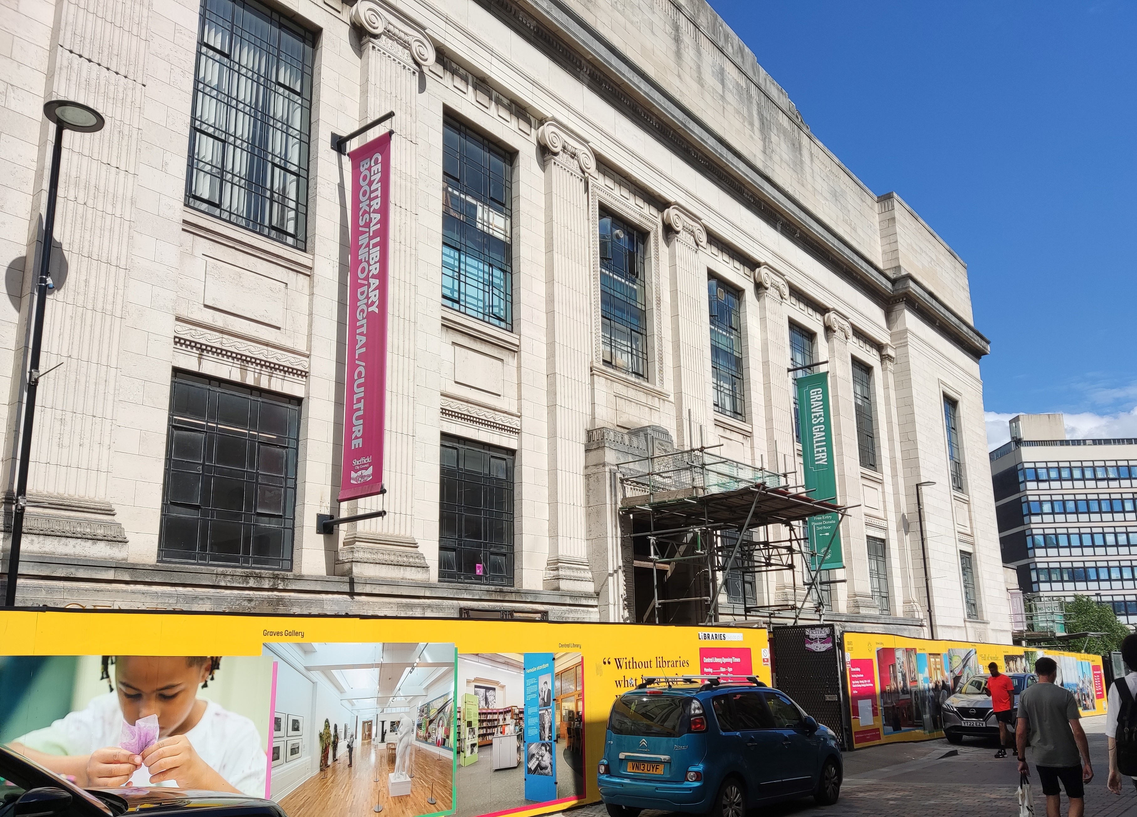 Sheffield Central Library on a sunny day. The uilding features neo-classical and art deco elements, with light stonework and decorative ionic columns across the facade. The Graves Gallery is located on the fourth floor above the library spaces.