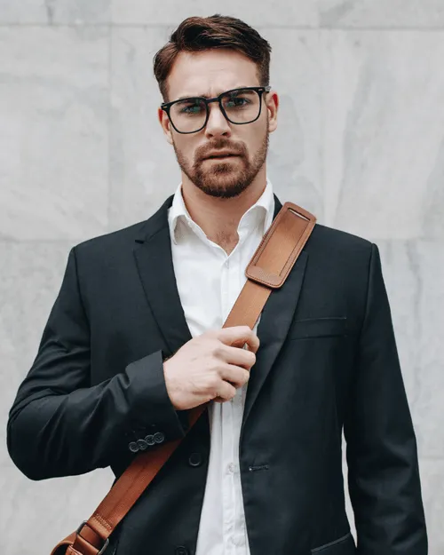 Man holding bag with glasses.
