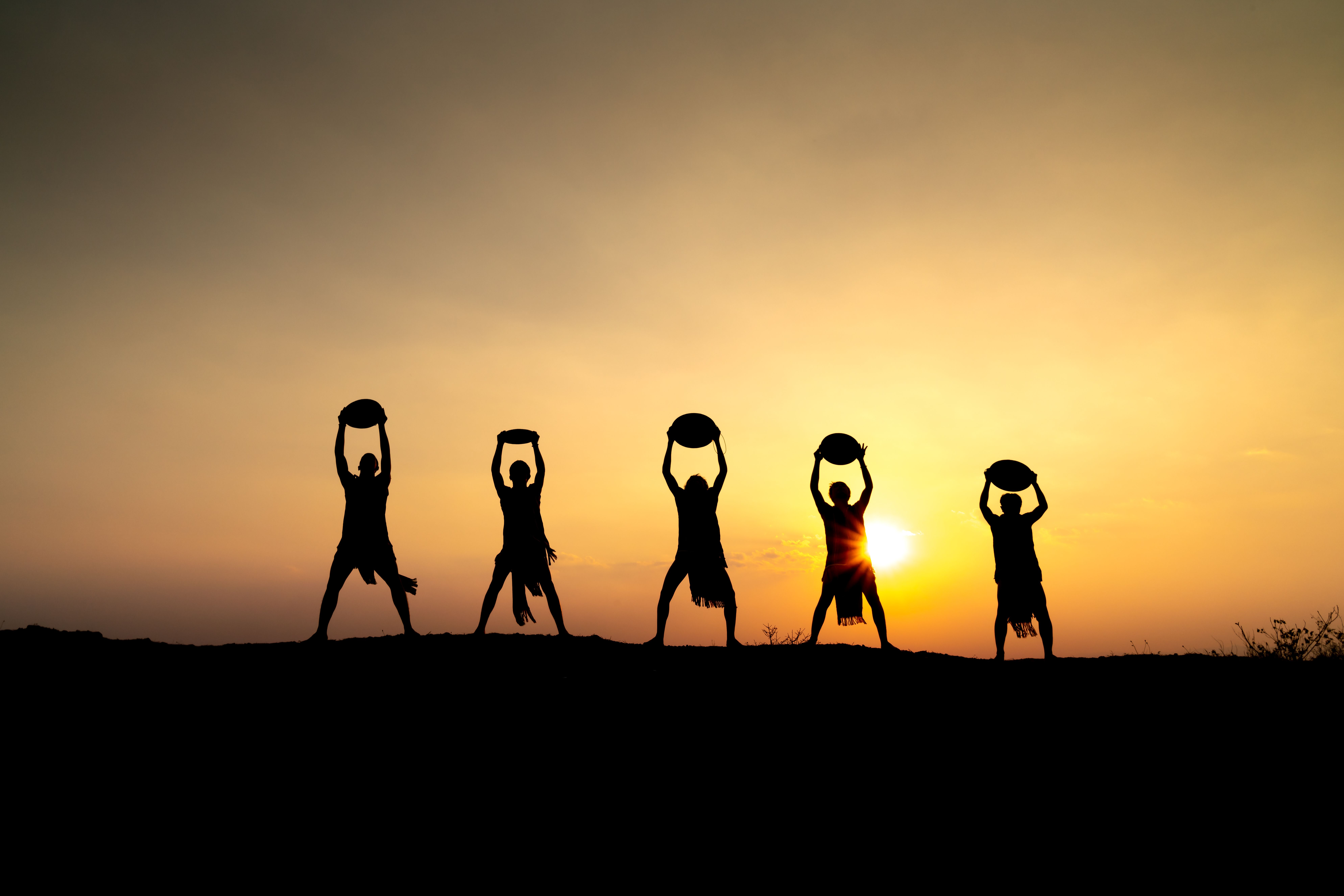 Silhouettes of five people as a symbol for teamwork and team performance