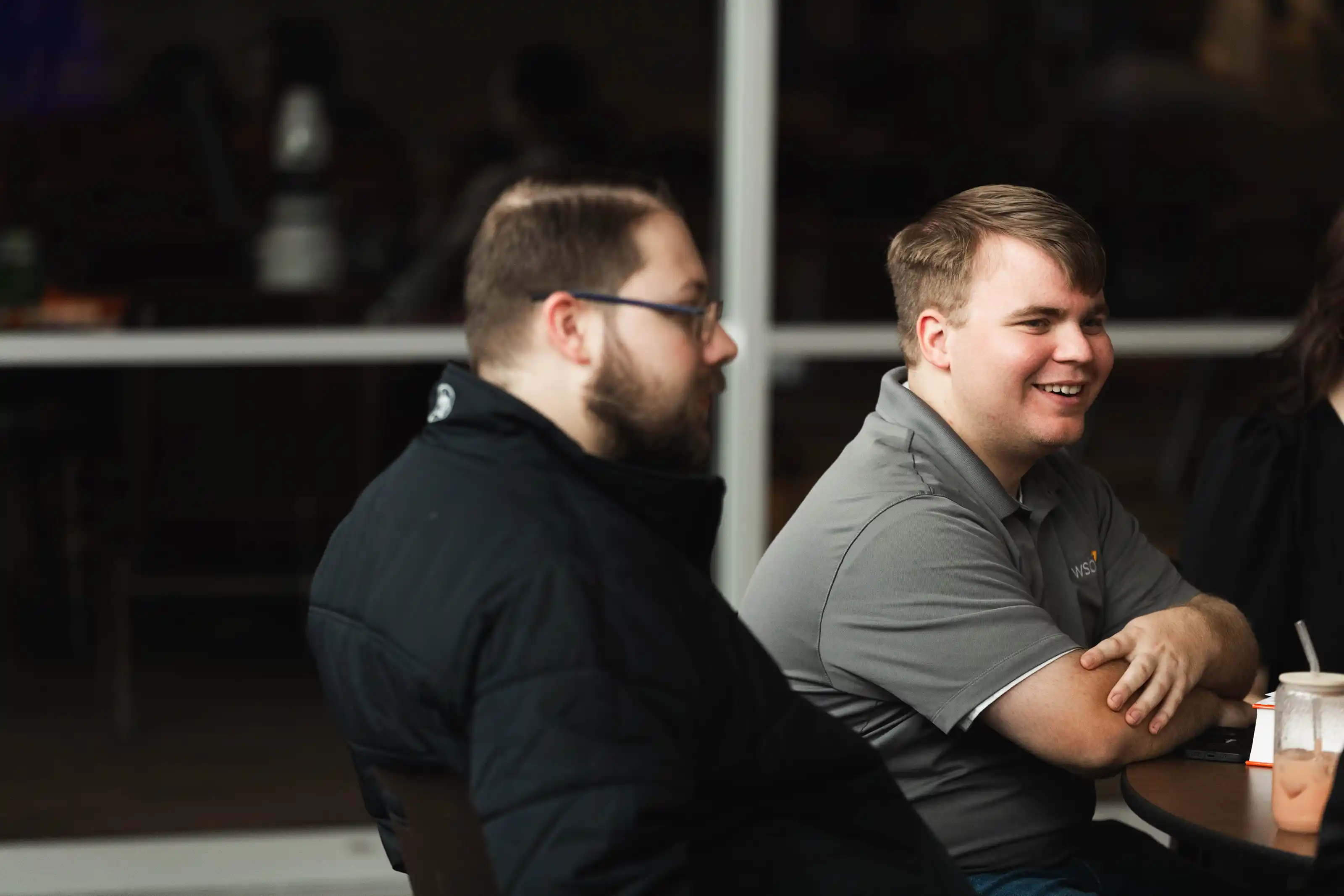 Congregation standing and singing during a church service with a worship band on stage.