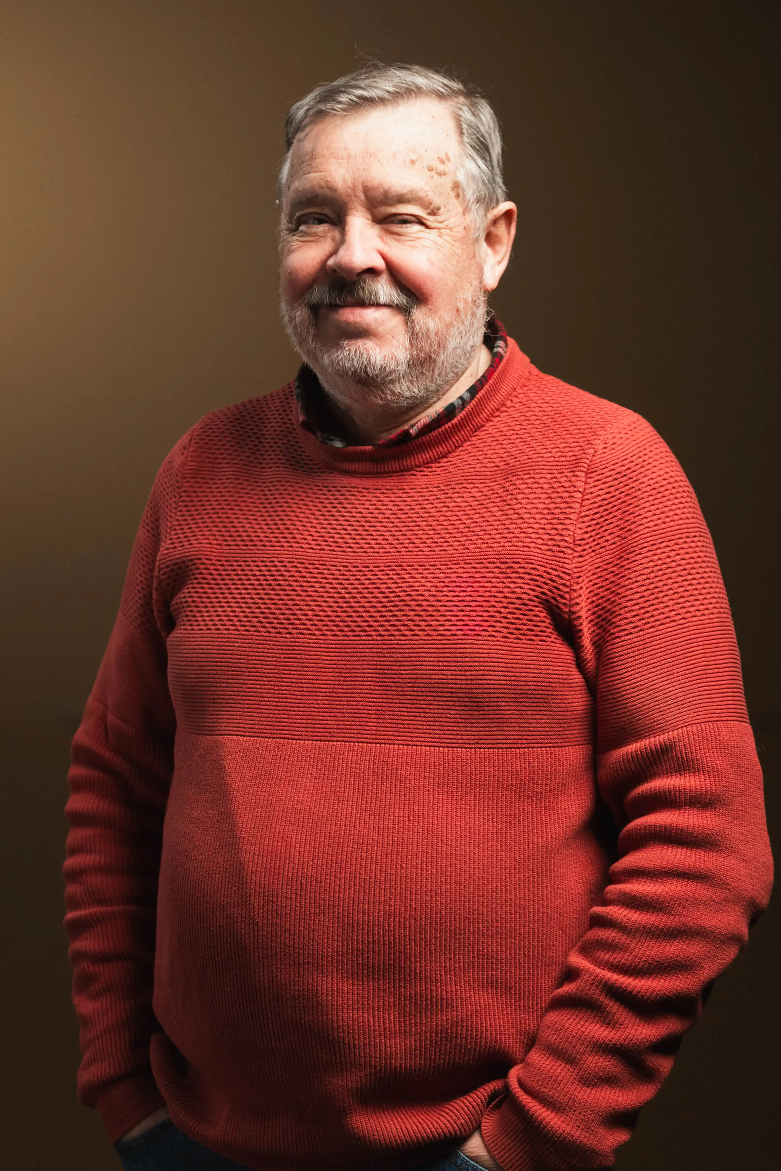 Congregation standing and singing during a church service with a worship band on stage.