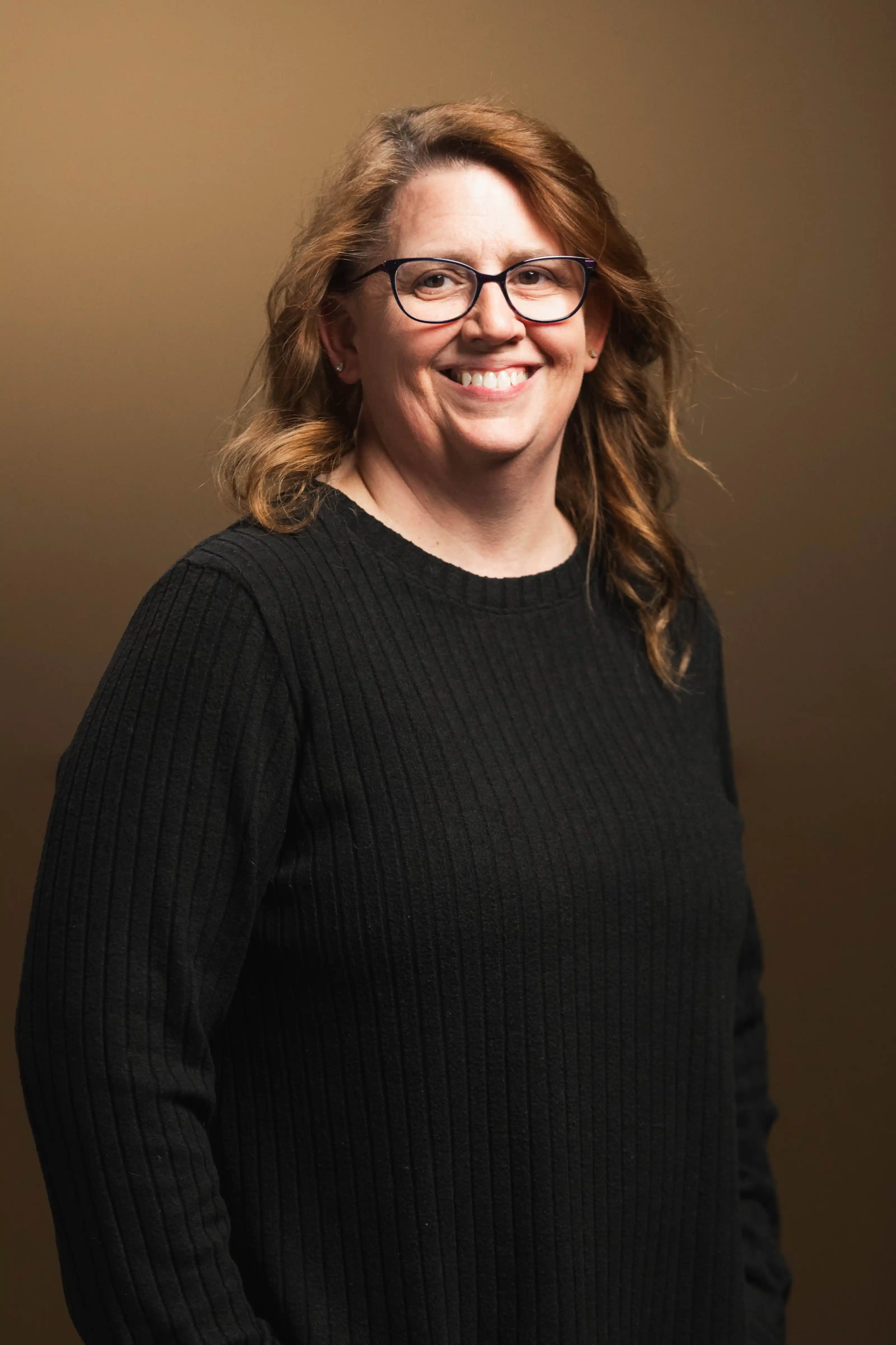 Congregation standing and singing during a church service with a worship band on stage.