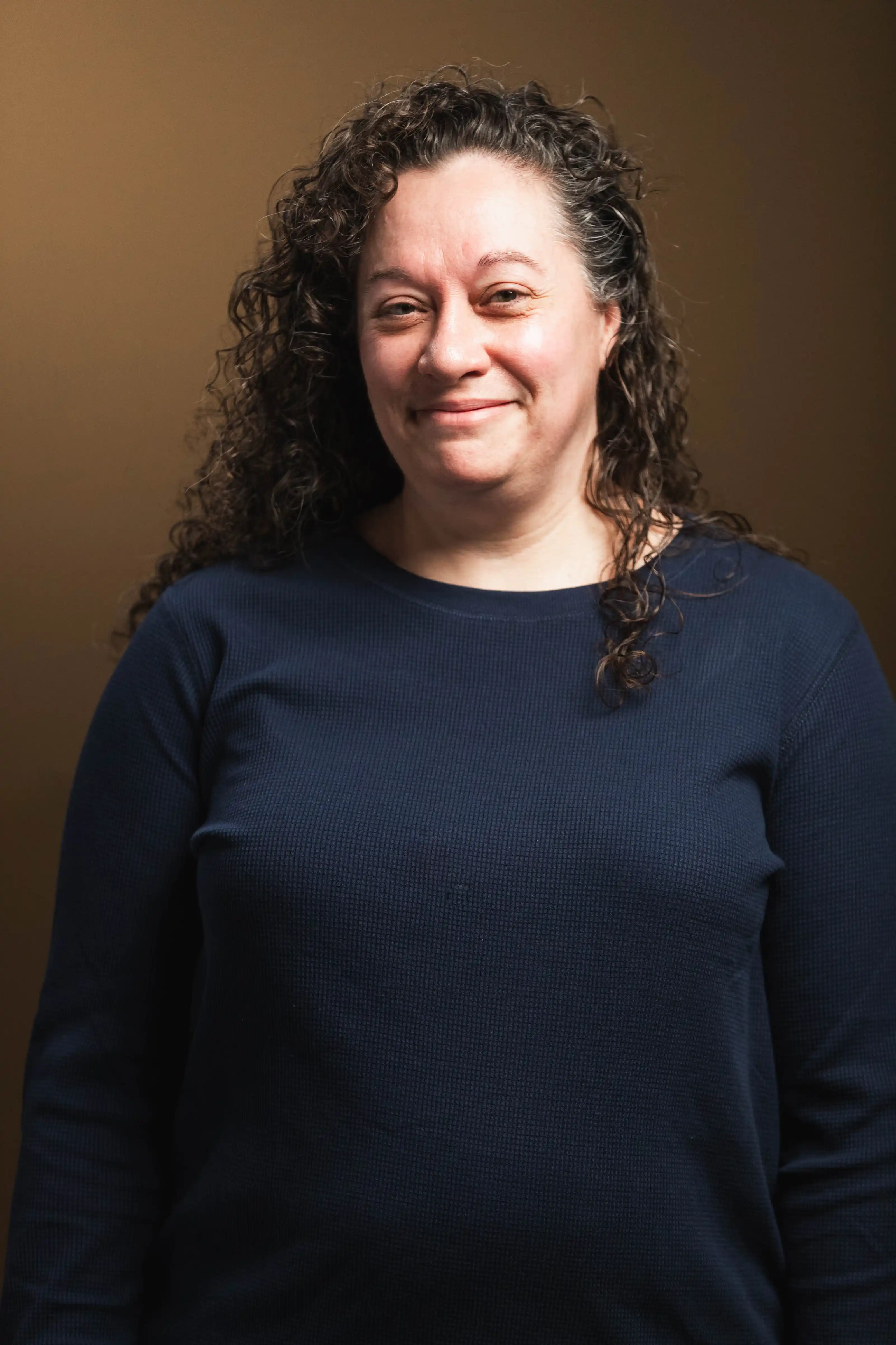 Congregation standing and singing during a church service with a worship band on stage.