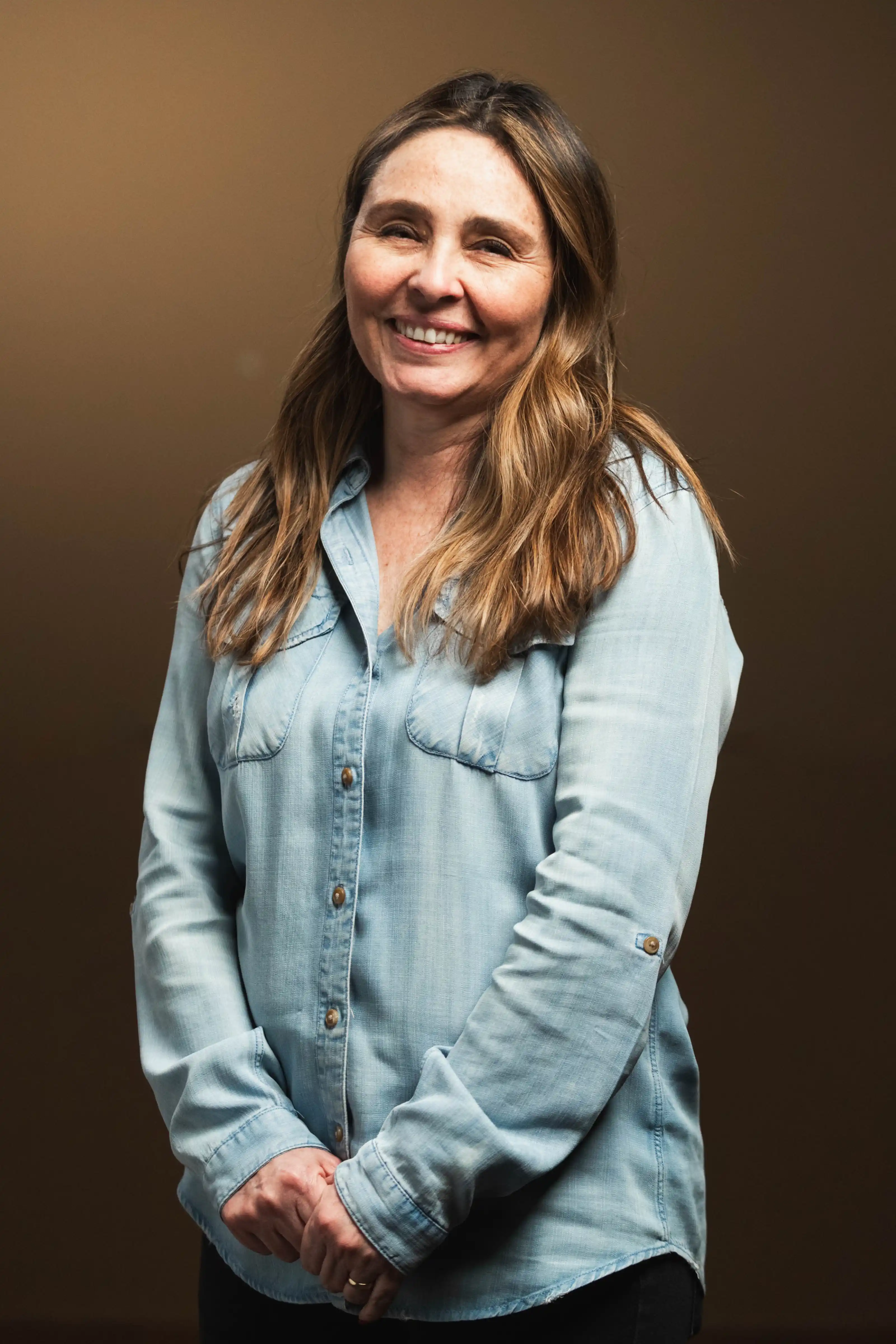 Congregation standing and singing during a church service with a worship band on stage.