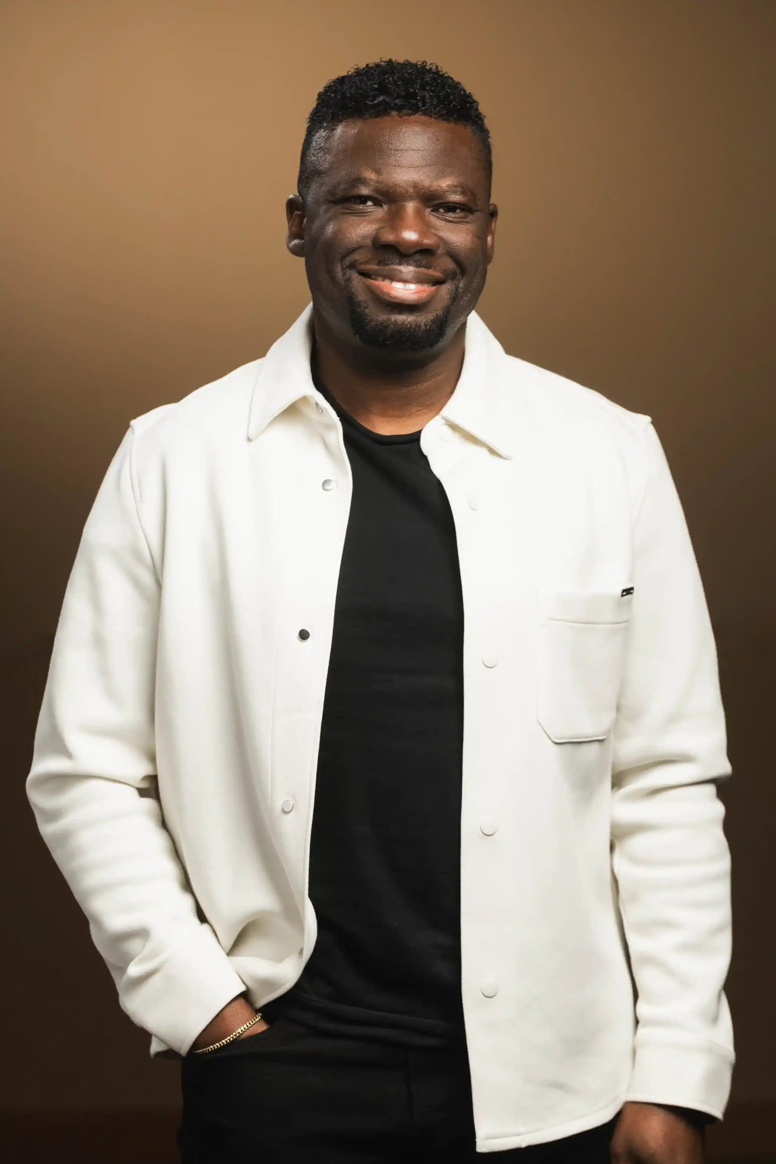 Congregation standing and singing during a church service with a worship band on stage.