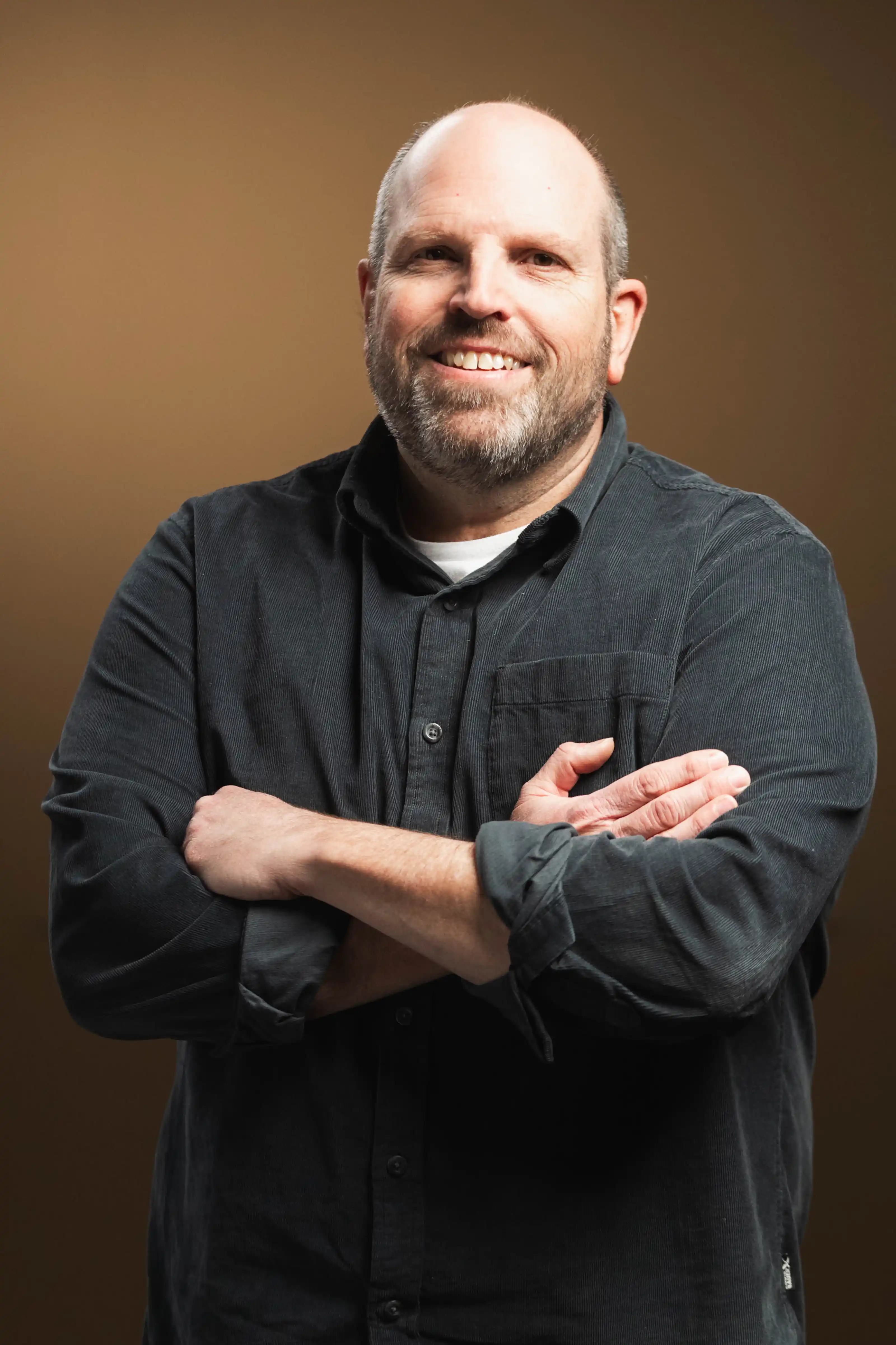 Congregation standing and singing during a church service with a worship band on stage.