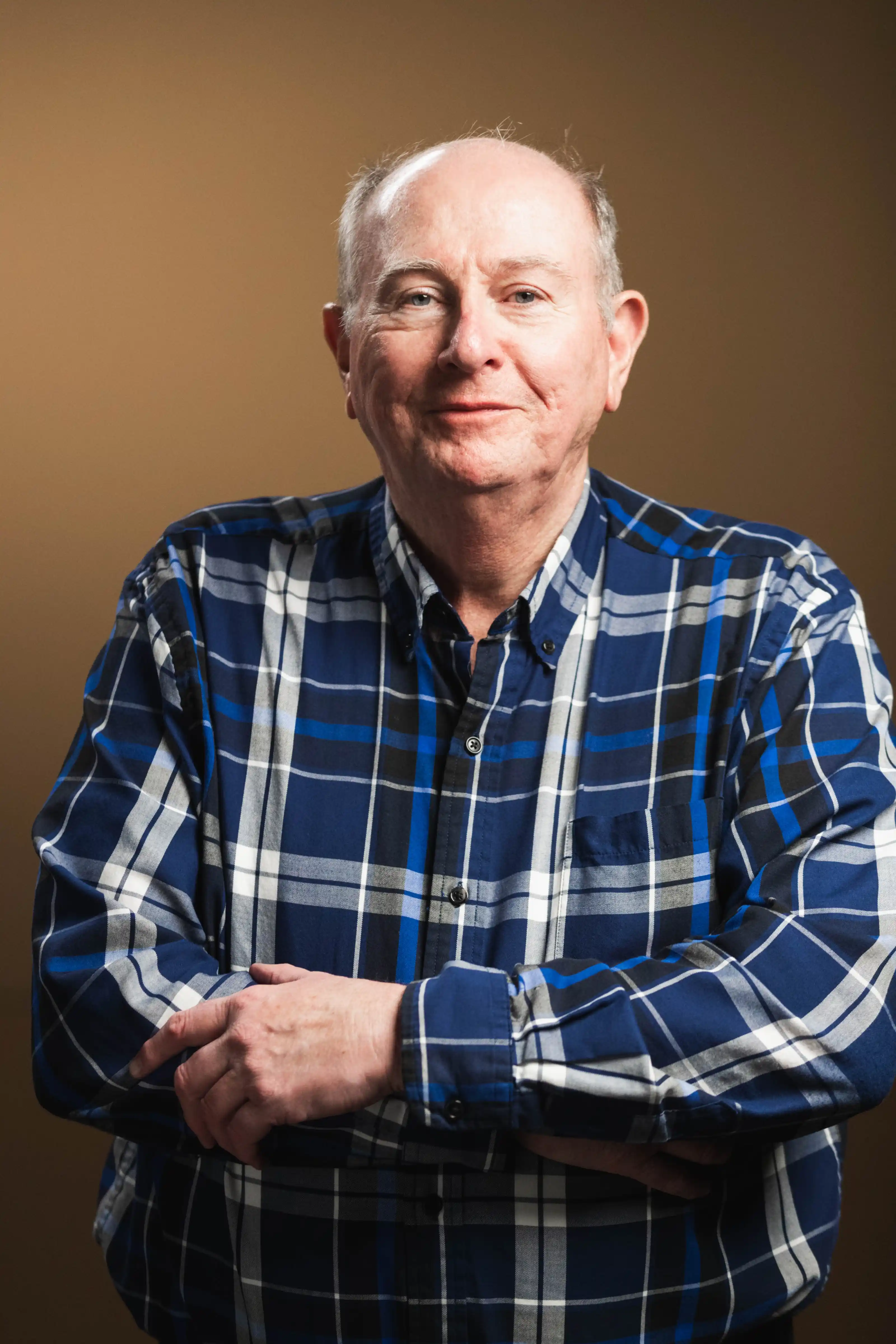 Congregation standing and singing during a church service with a worship band on stage.