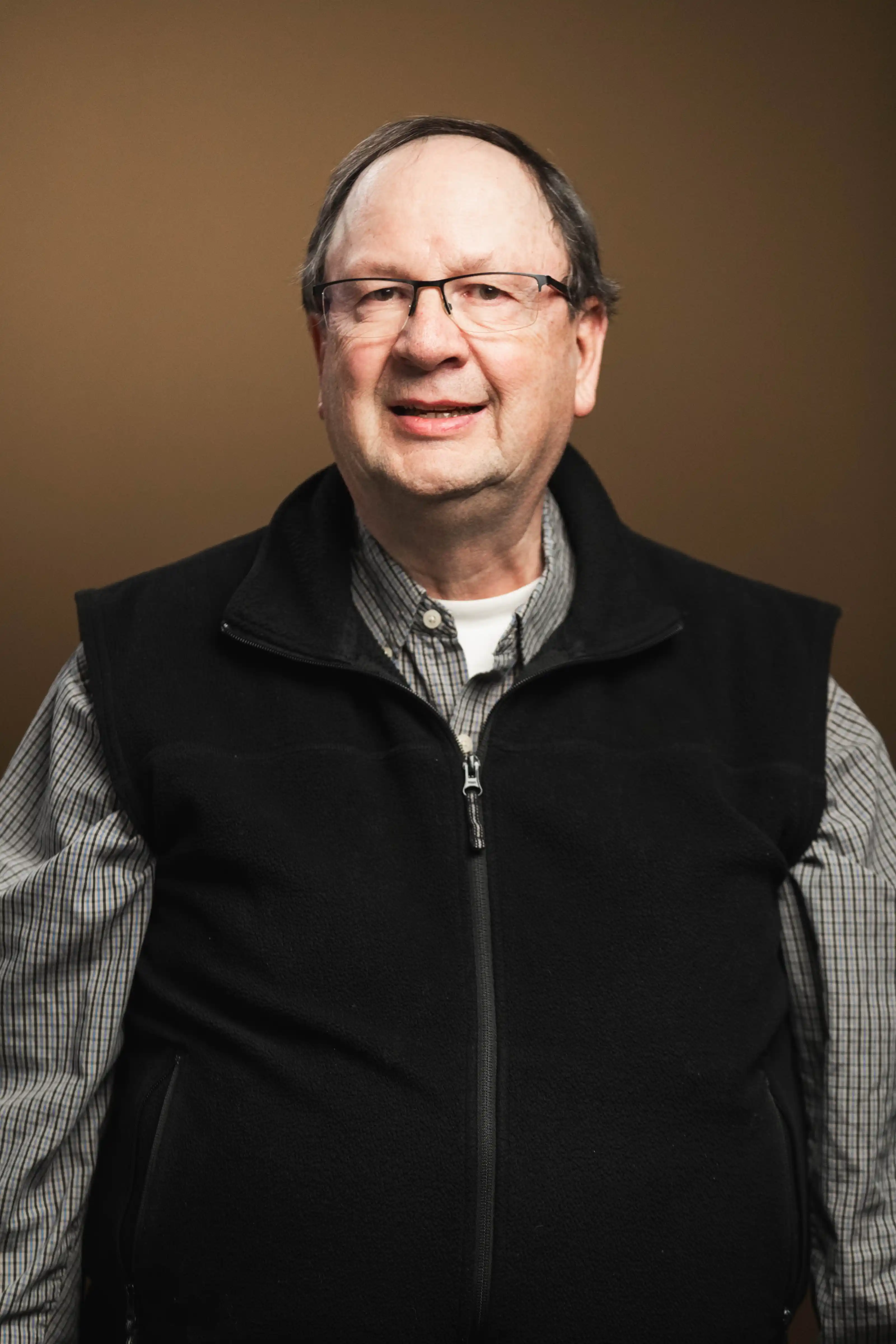 Congregation standing and singing during a church service with a worship band on stage.