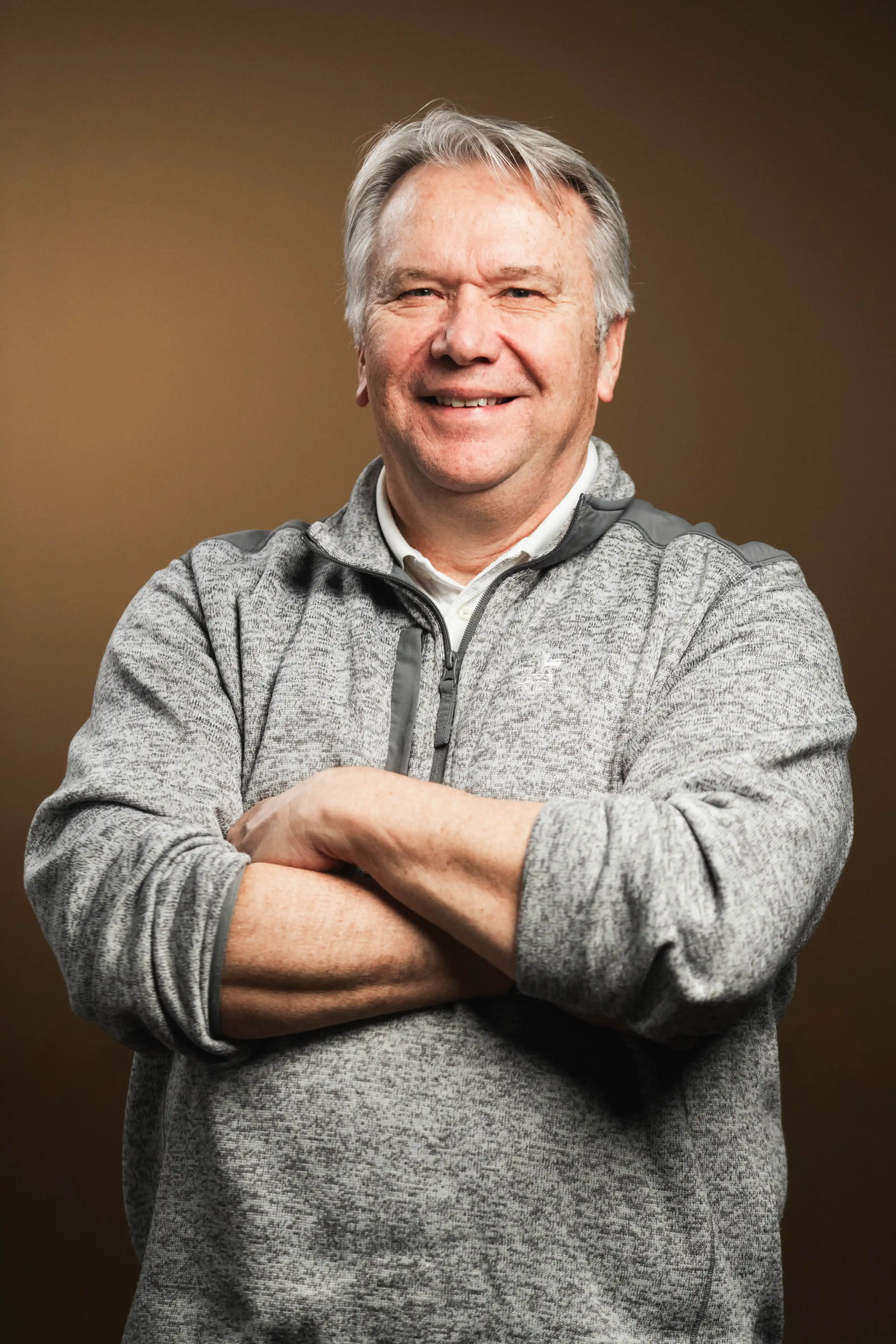 Congregation standing and singing during a church service with a worship band on stage.