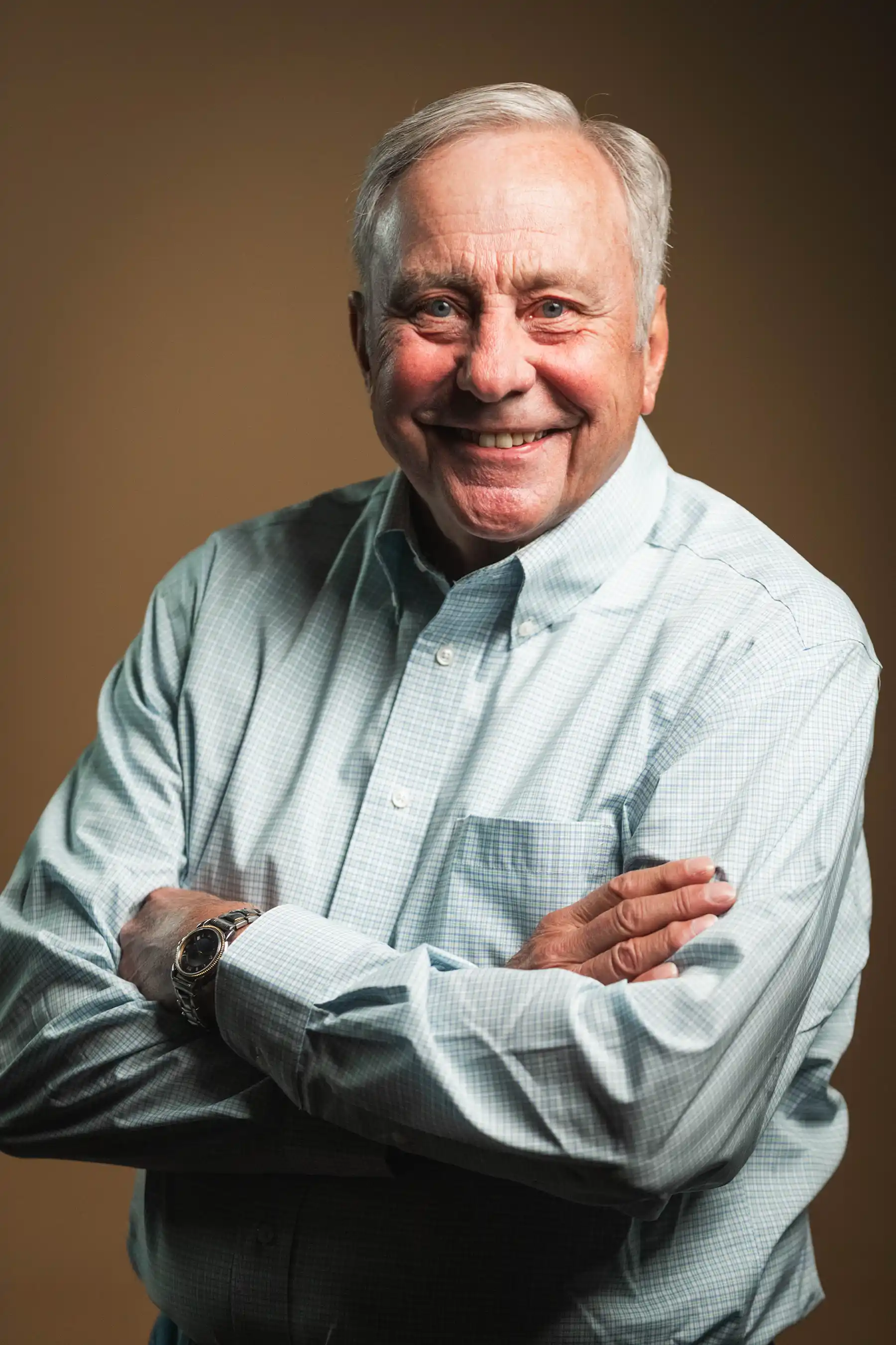 Congregation standing and singing during a church service with a worship band on stage.