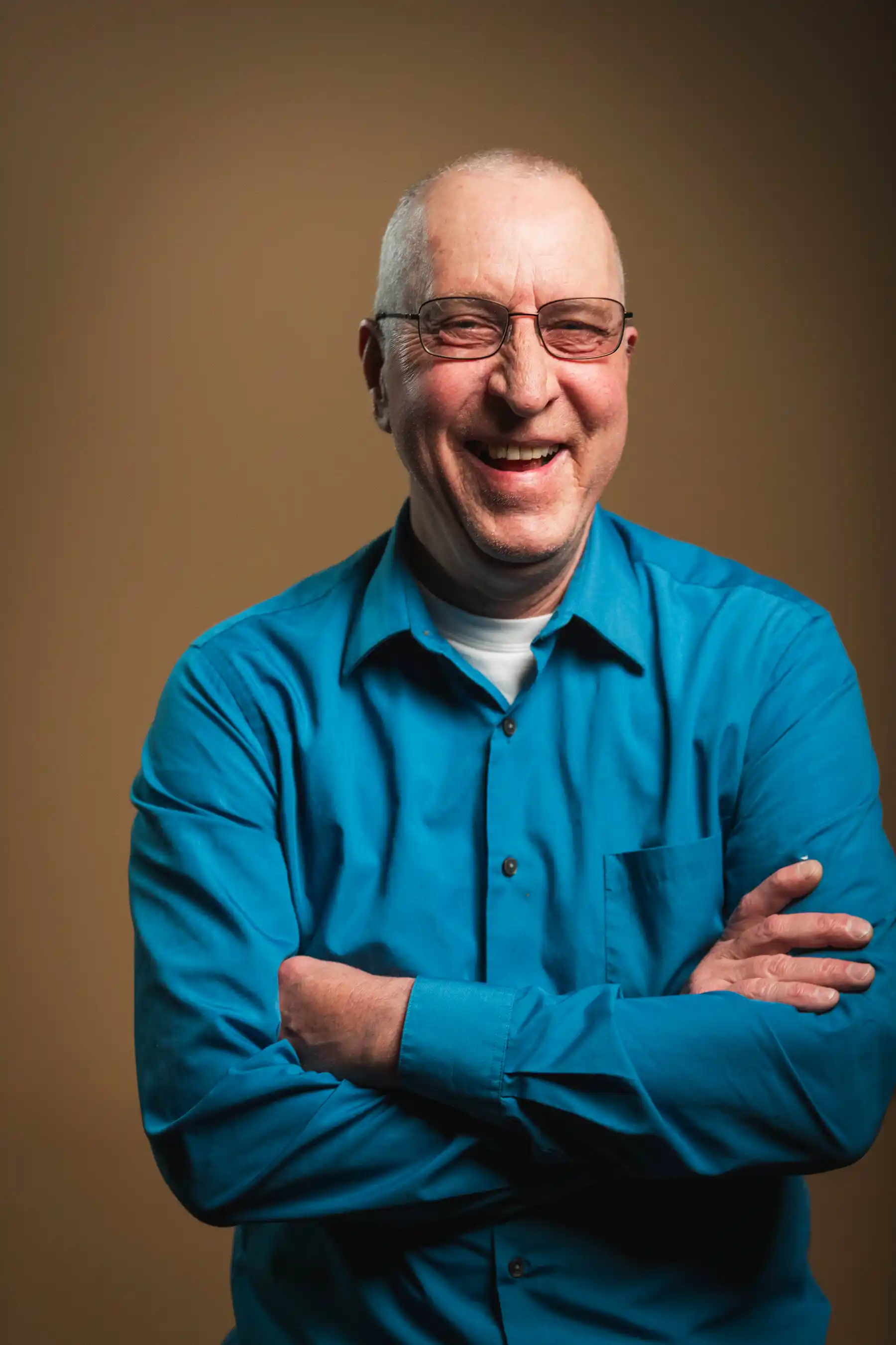 Congregation standing and singing during a church service with a worship band on stage.