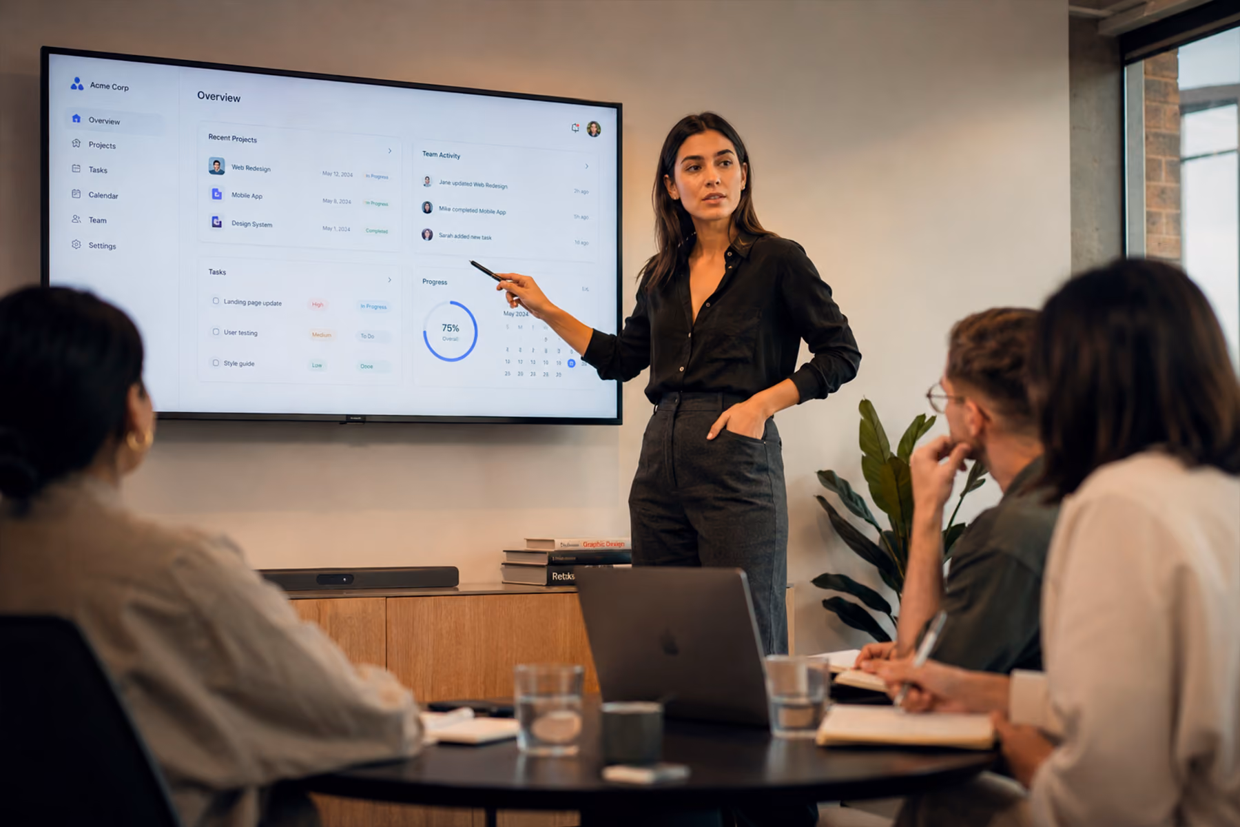 Senior UX designer presenting a product flow to a small focused team in a modern studio