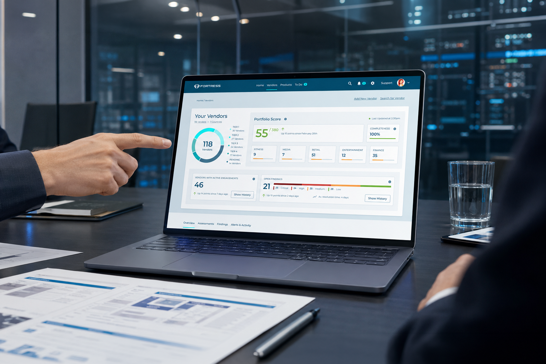 Laptop mockup displaying a cybersecurity desktop webpage in a modern corporate meeting room with an enterprise compliance review atmosphere.