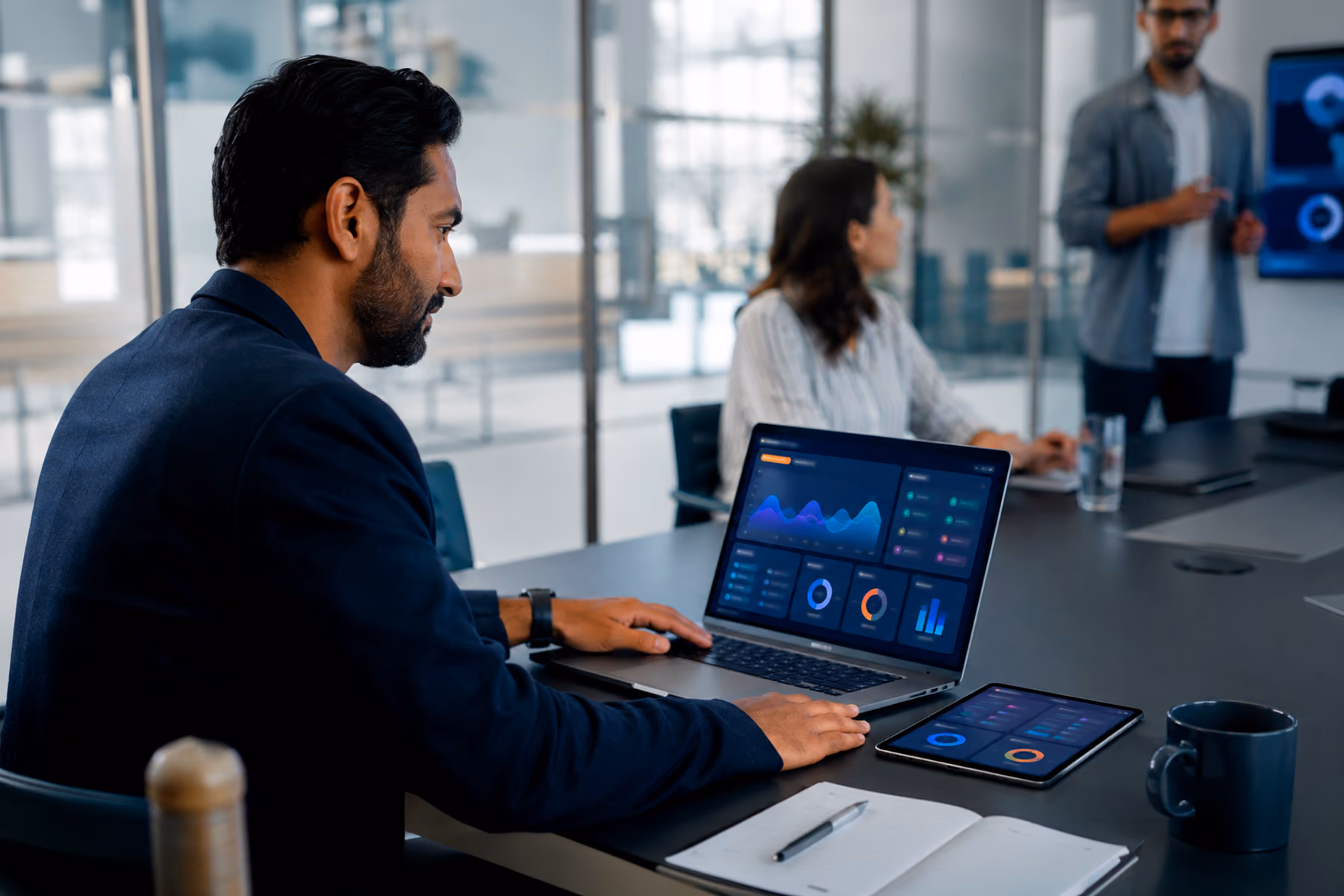 Product leader checking abstract dashboard interfaces across laptop and mobile devices during a real workday.