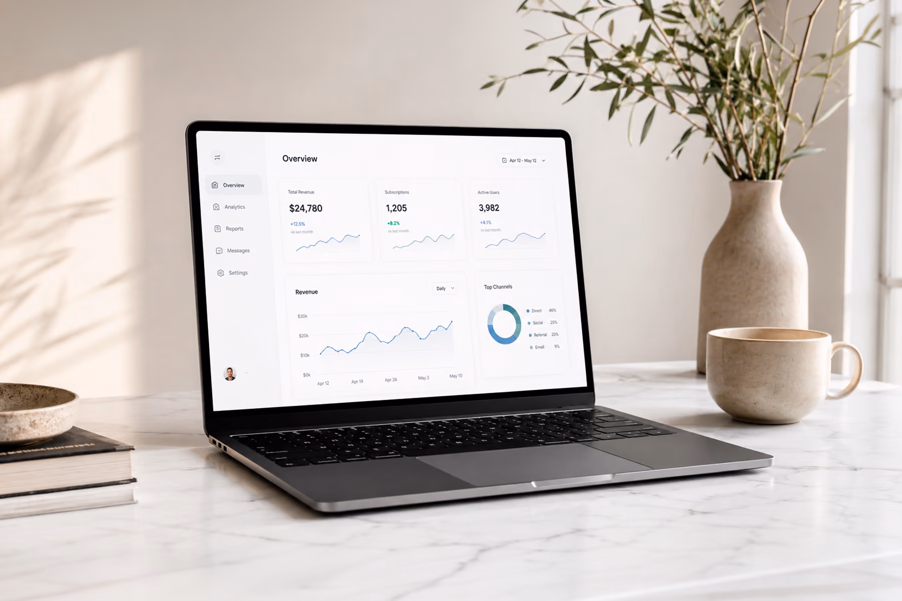 Minimalist dashboard UI with white space displayed on a laptop on a clean desk