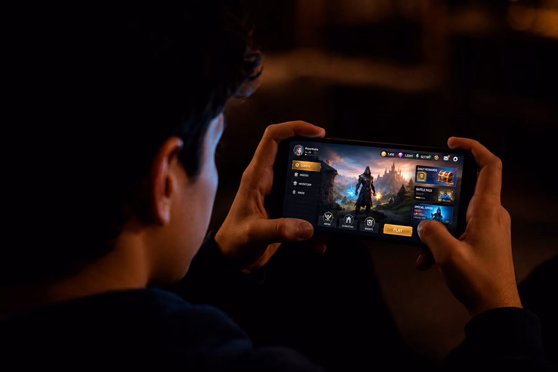 Gamer evaluating a mobile game UI for the first time, face lit by screen glow in a dark environment