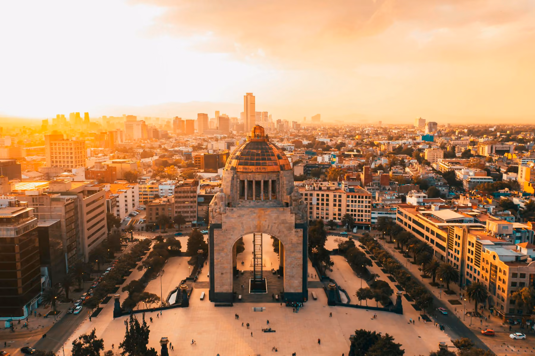 Aerial view of Mexico City skyline at golden hour showing modern business district and urban growth