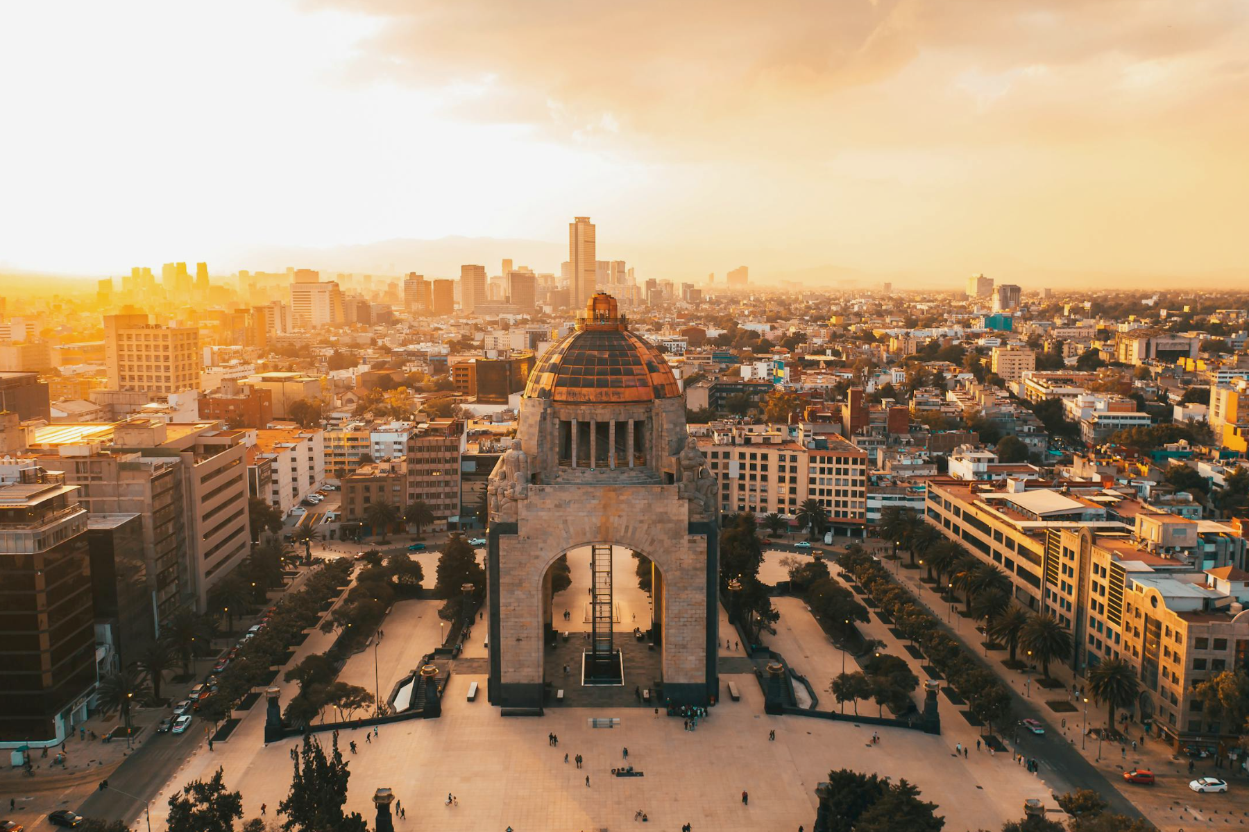 Aerial view of Mexico City skyline at golden hour showing modern business district and urban growth