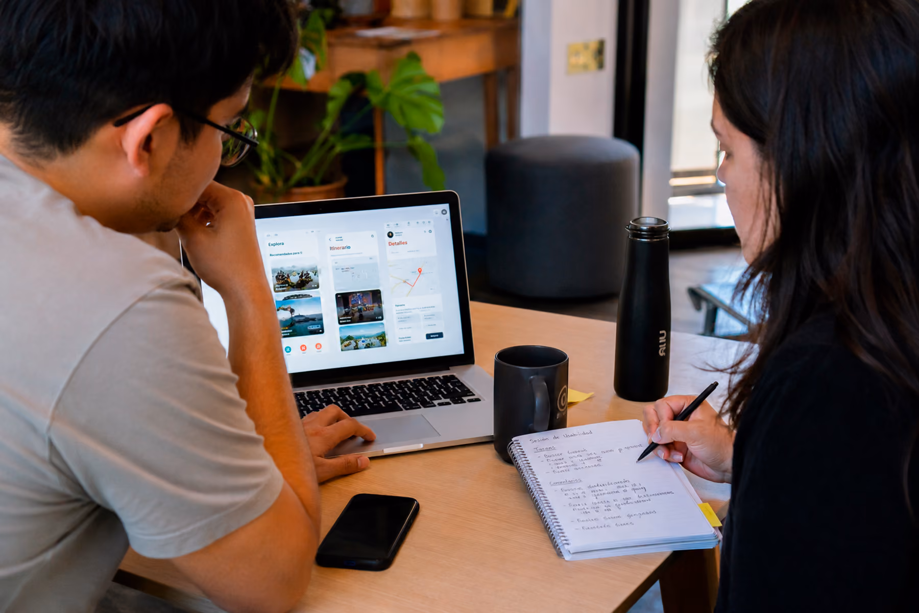 UX researcher conducting startup usability testing session with participant interacting with mobile app prototype
