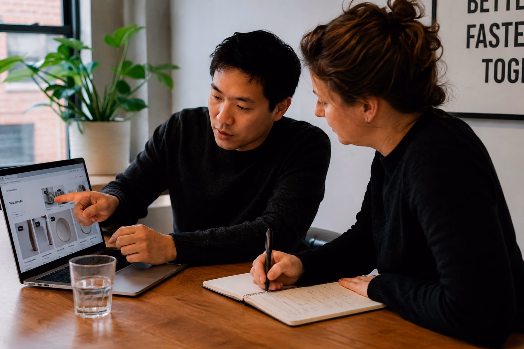 UX researcher conducting in-person user research session with participant and handwritten notes