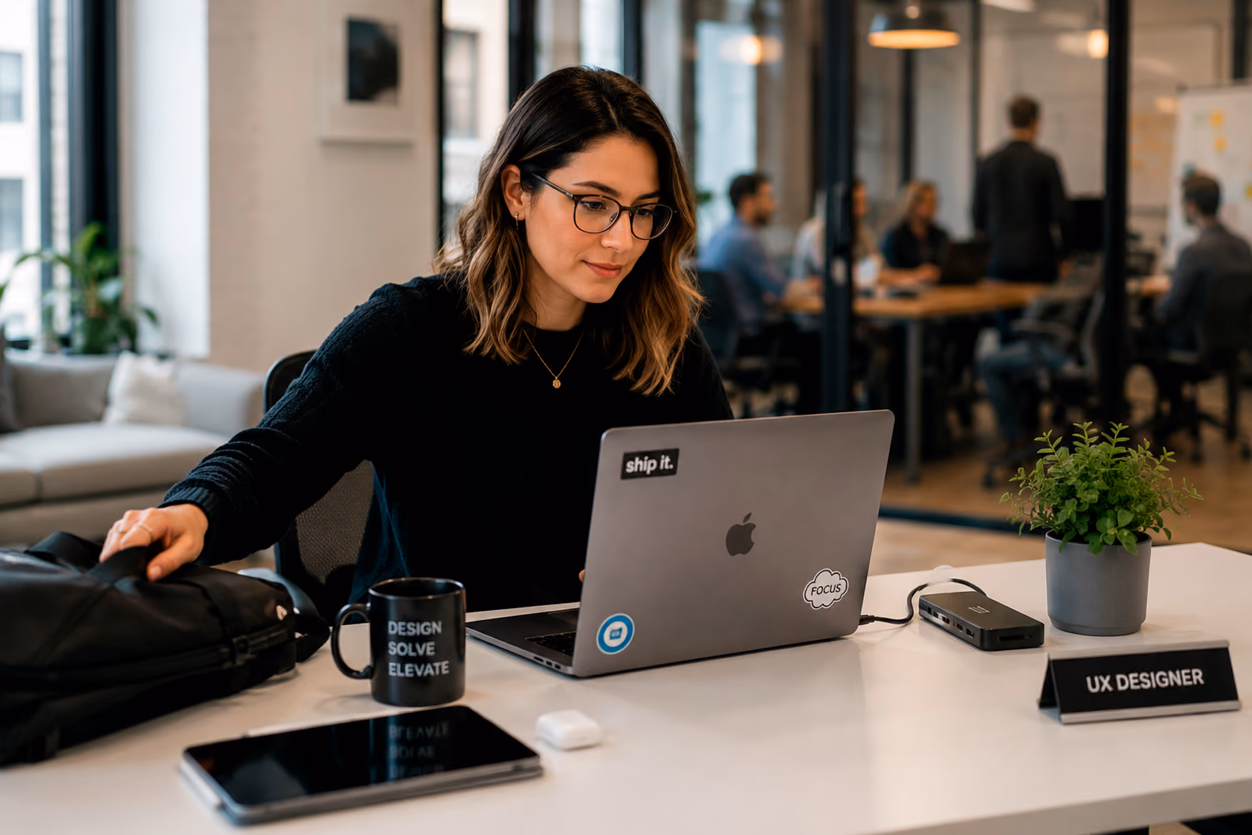 UX staff augmentation designer setting up their own laptop and tools at a client workstation ready to work from day one