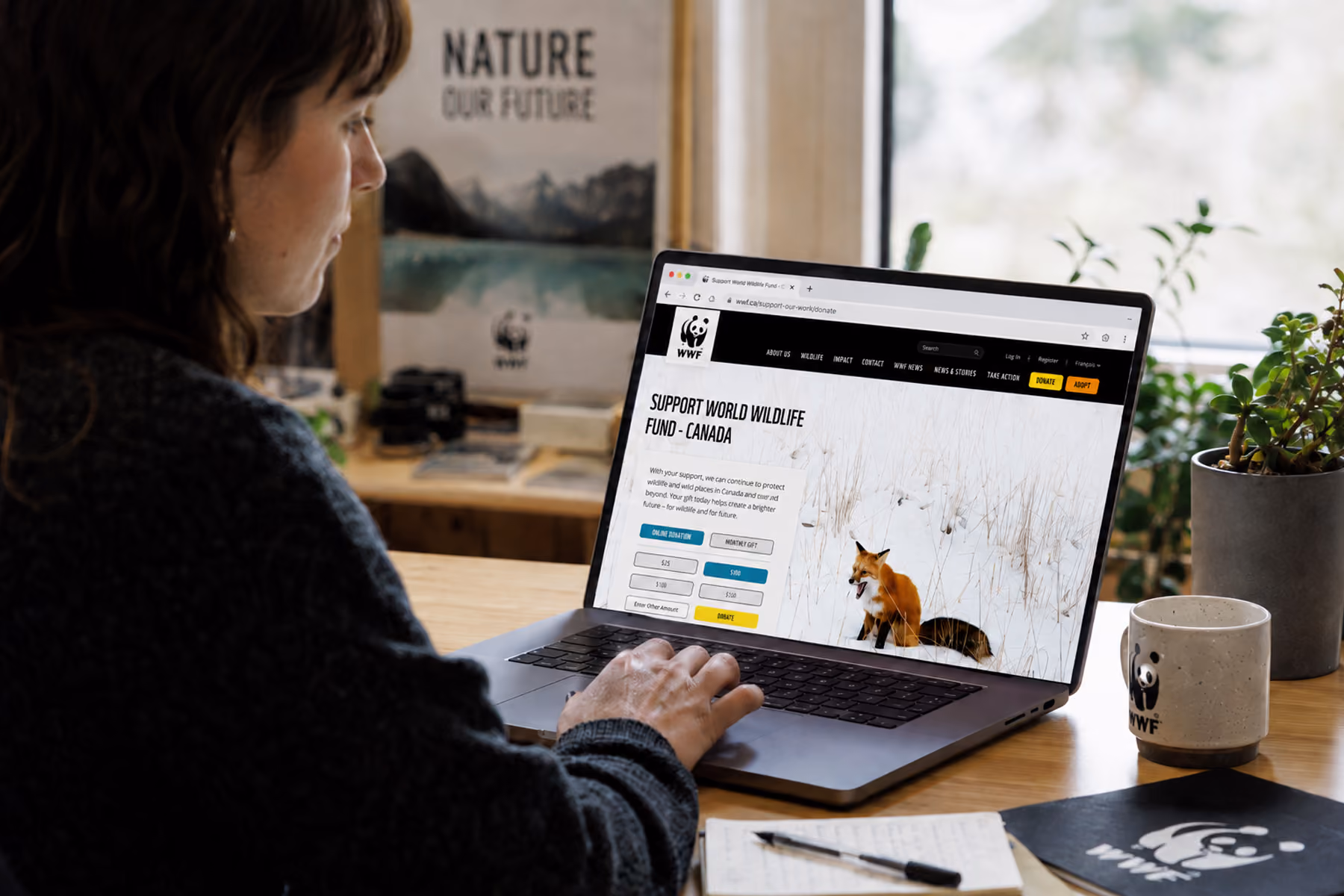 WWF Canada donation funnel redesigned by WANDR displayed on laptop showing simplified mobile-optimized giving flow