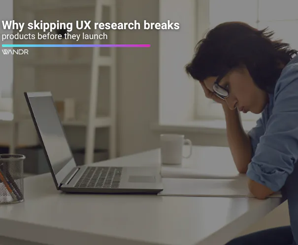 UX researcher reviewing user behavior data and wireframes on a whiteboard during early-stage product design planning