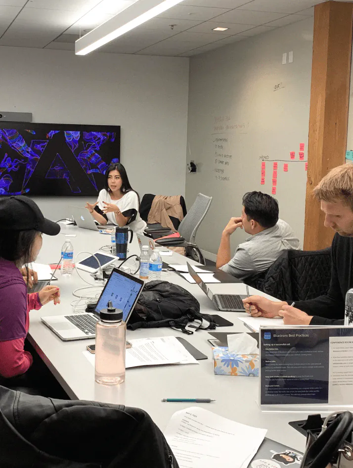 UX researcher reviewing user interview notes and journey maps on a whiteboard during a product design session
